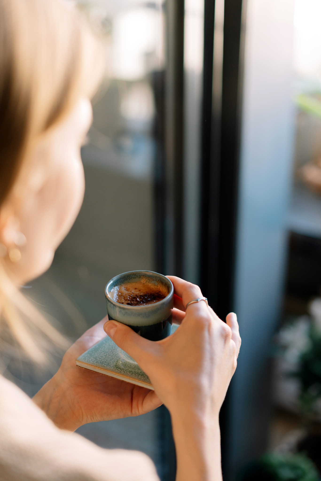 Midsection of woman holding coffee cup