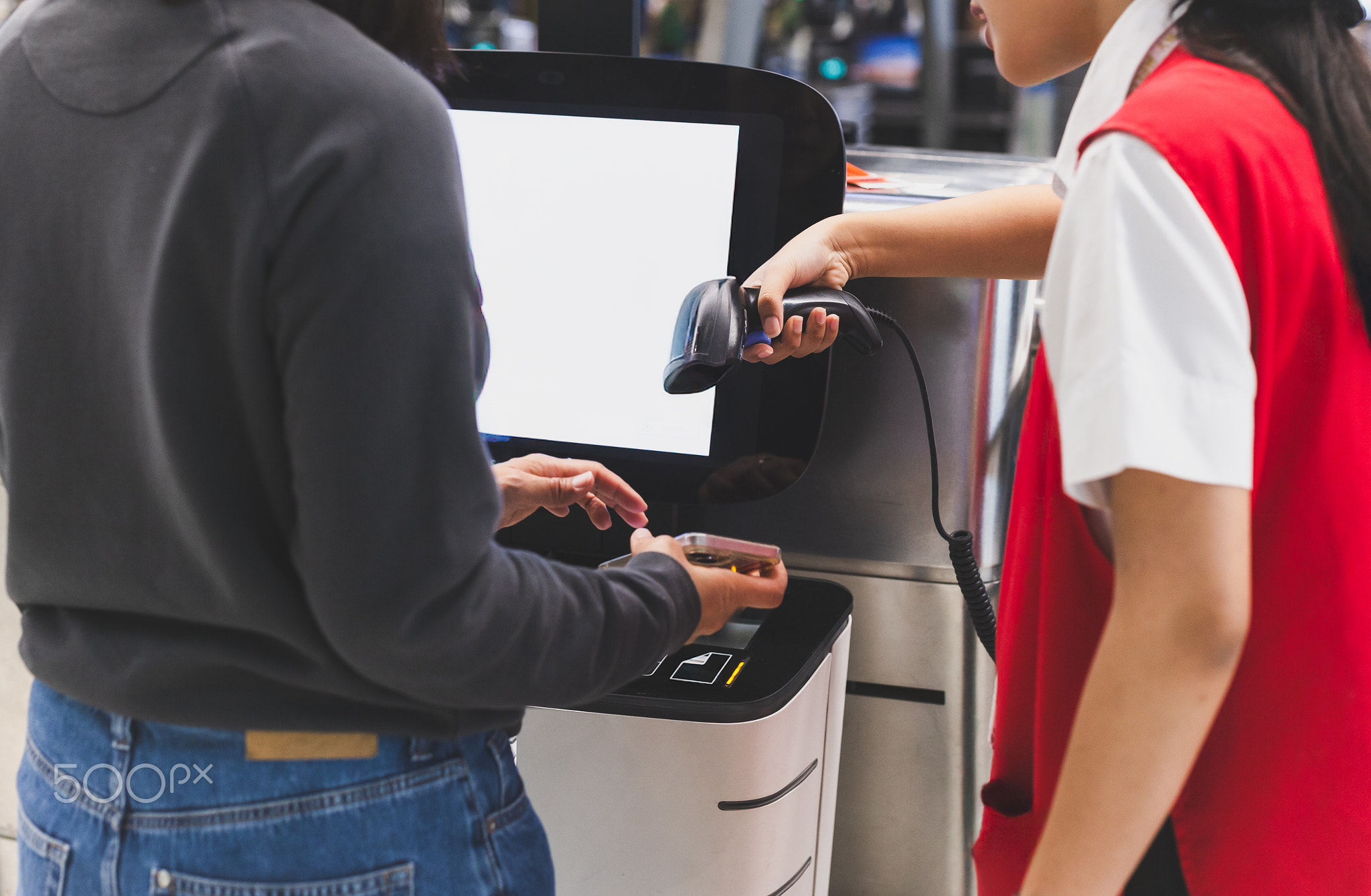 Woman self check in with hand scanning barcode in the airport.