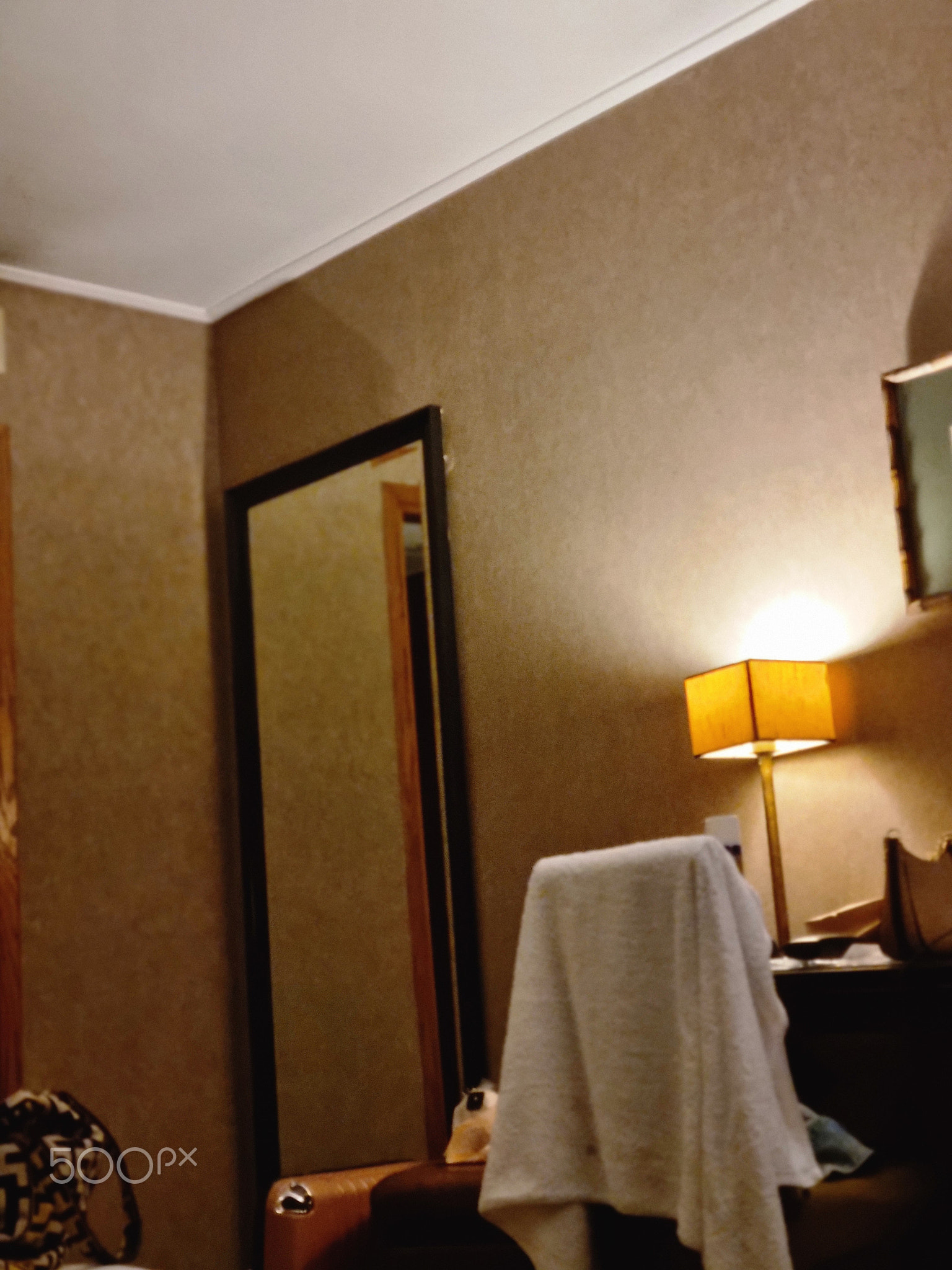 Cozy Hotel Room Corner with Mirror and Warm Lighting
