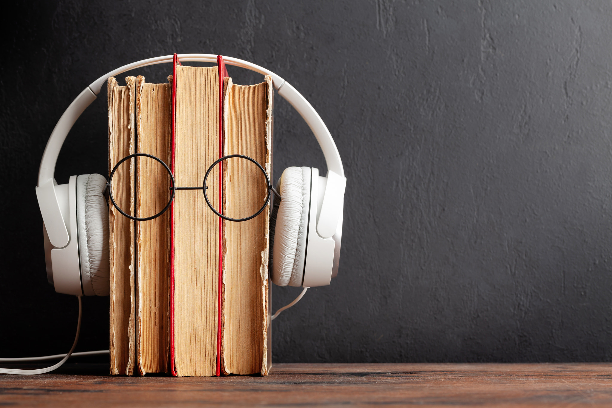 Old books, headphones and eyeglasses