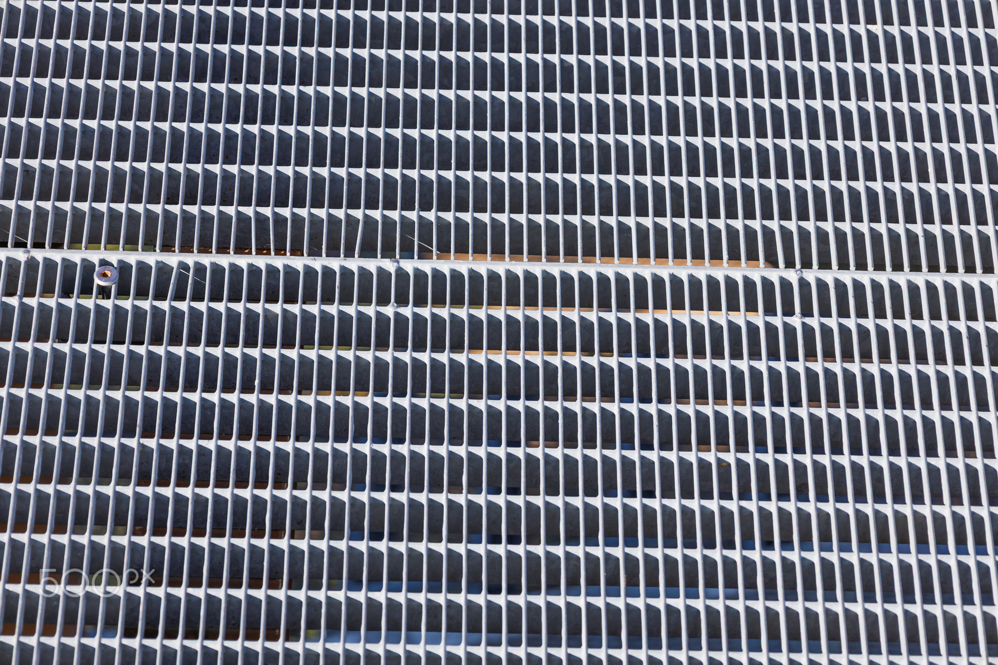 Closeup of Metallic Ventilation Grille with Repetitive Horizontal Slats Abstract Texture