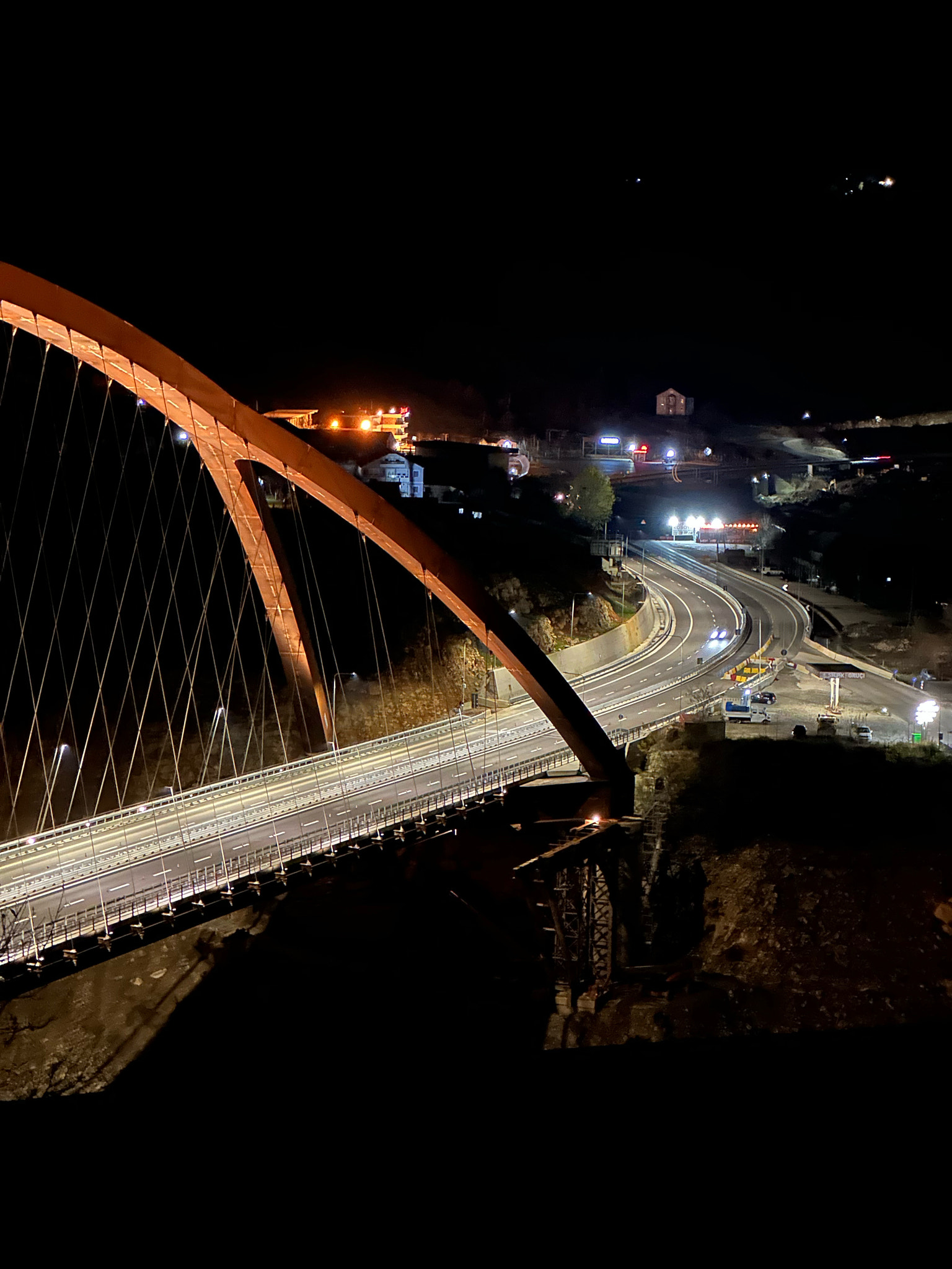 View of illuminated bridge over river at night