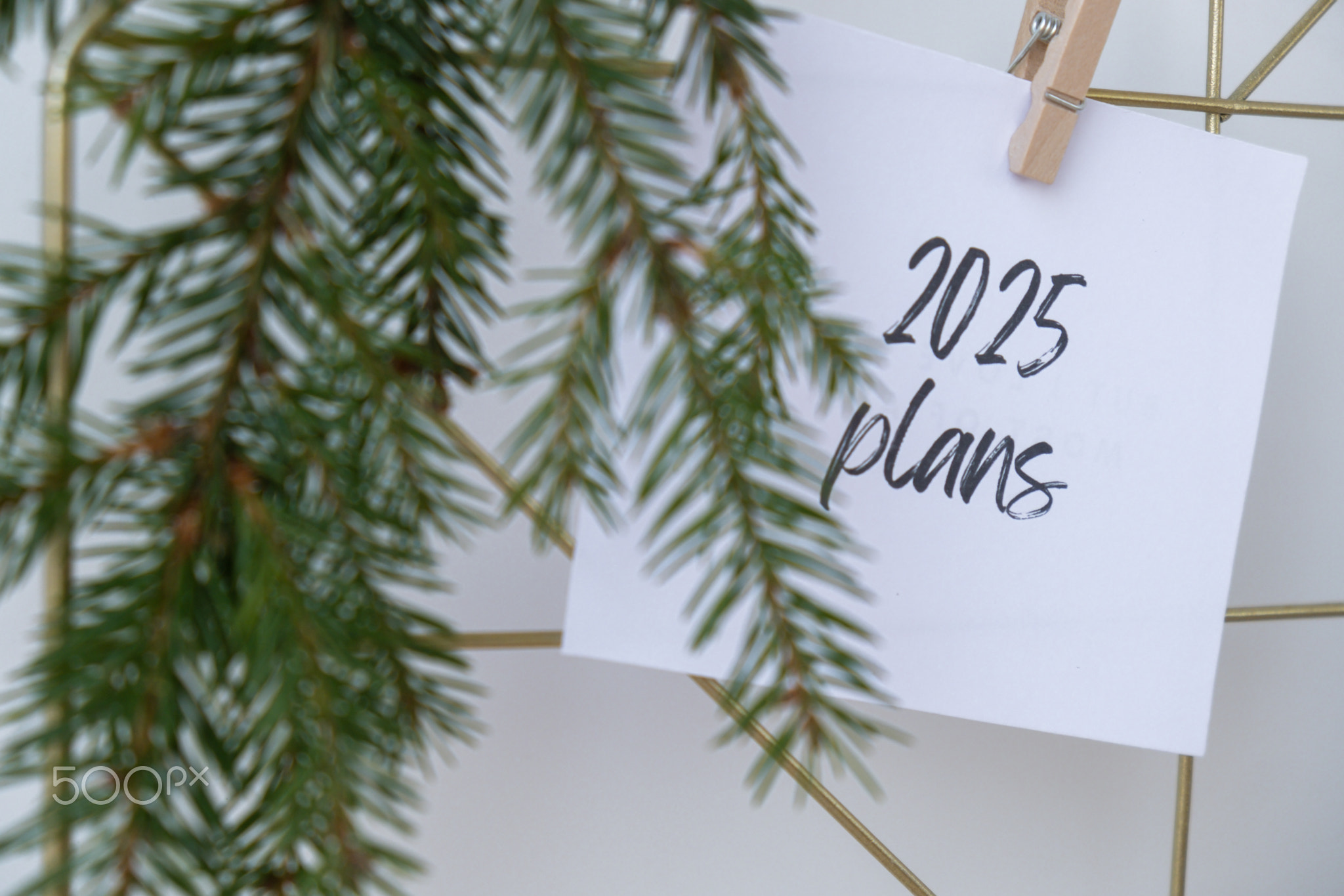 2025 PLANS text on white paper note on vision board with Christmas