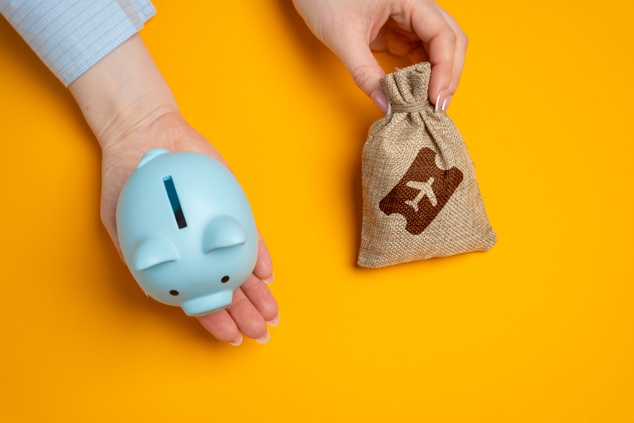 Piggy bank and a bag of airline tickets. The concept of saving on flights, accumulating bonuses and