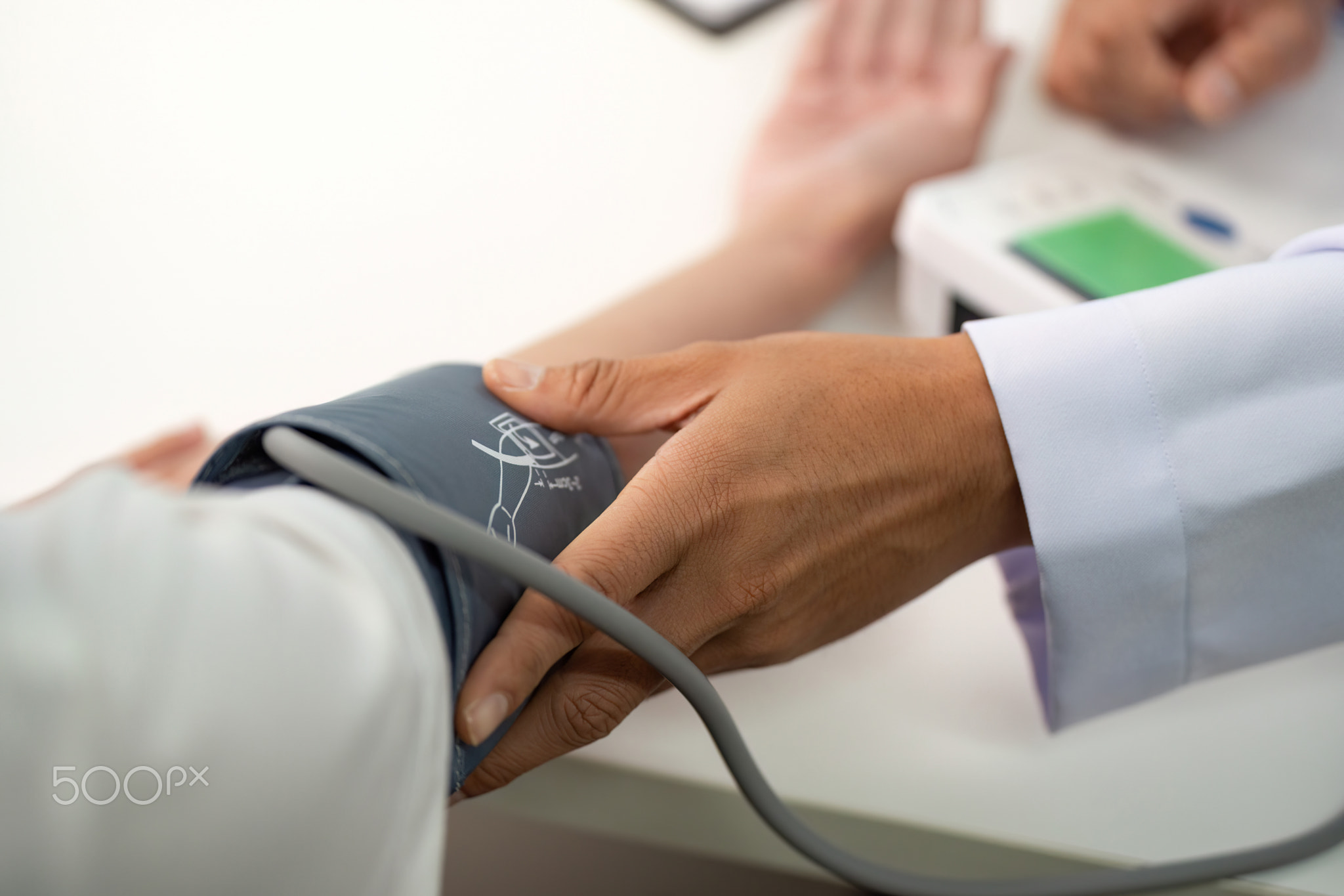 Blood Pressure Monitoring. Doctor measuring patient's blood pressure