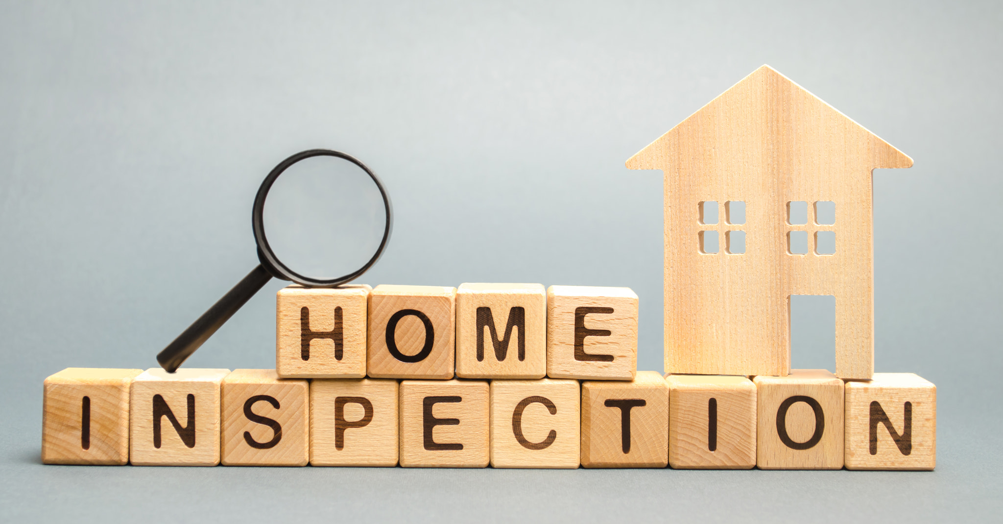 Wooden blocks with the word Home Inspection and the house. Resale residential property condition. Th