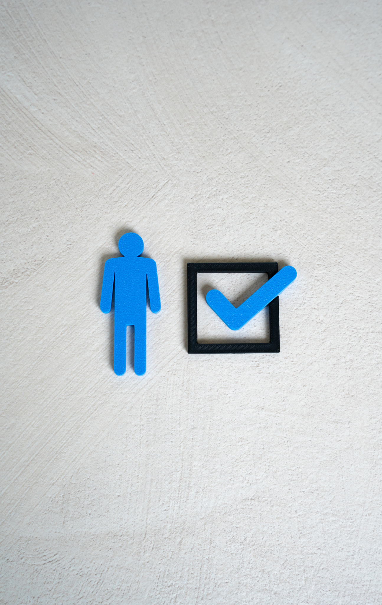 A human figure and a check mark in a checkbox. The concept of compliance with criteria. To mark ones