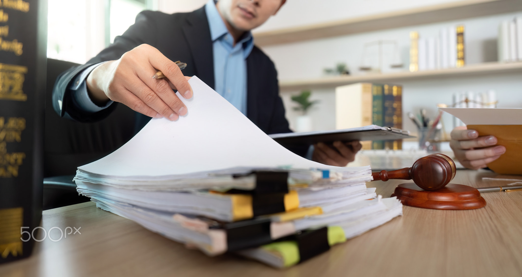 Document Review. Lawyer examining legal files during client meeting.