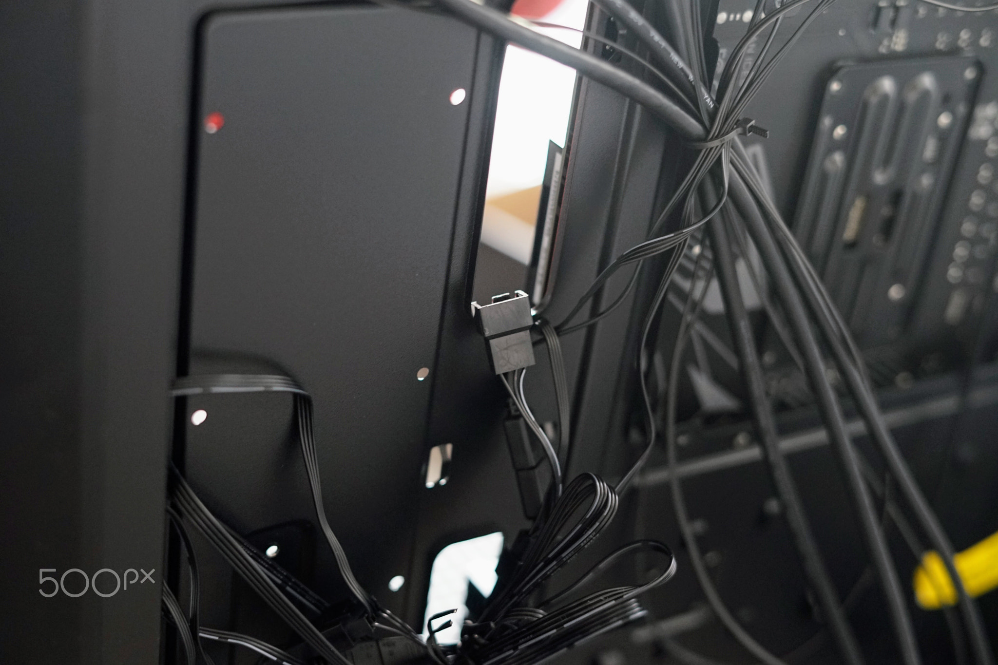 Tangled and Cluttered Cables Behind a Computer Workstation Setup