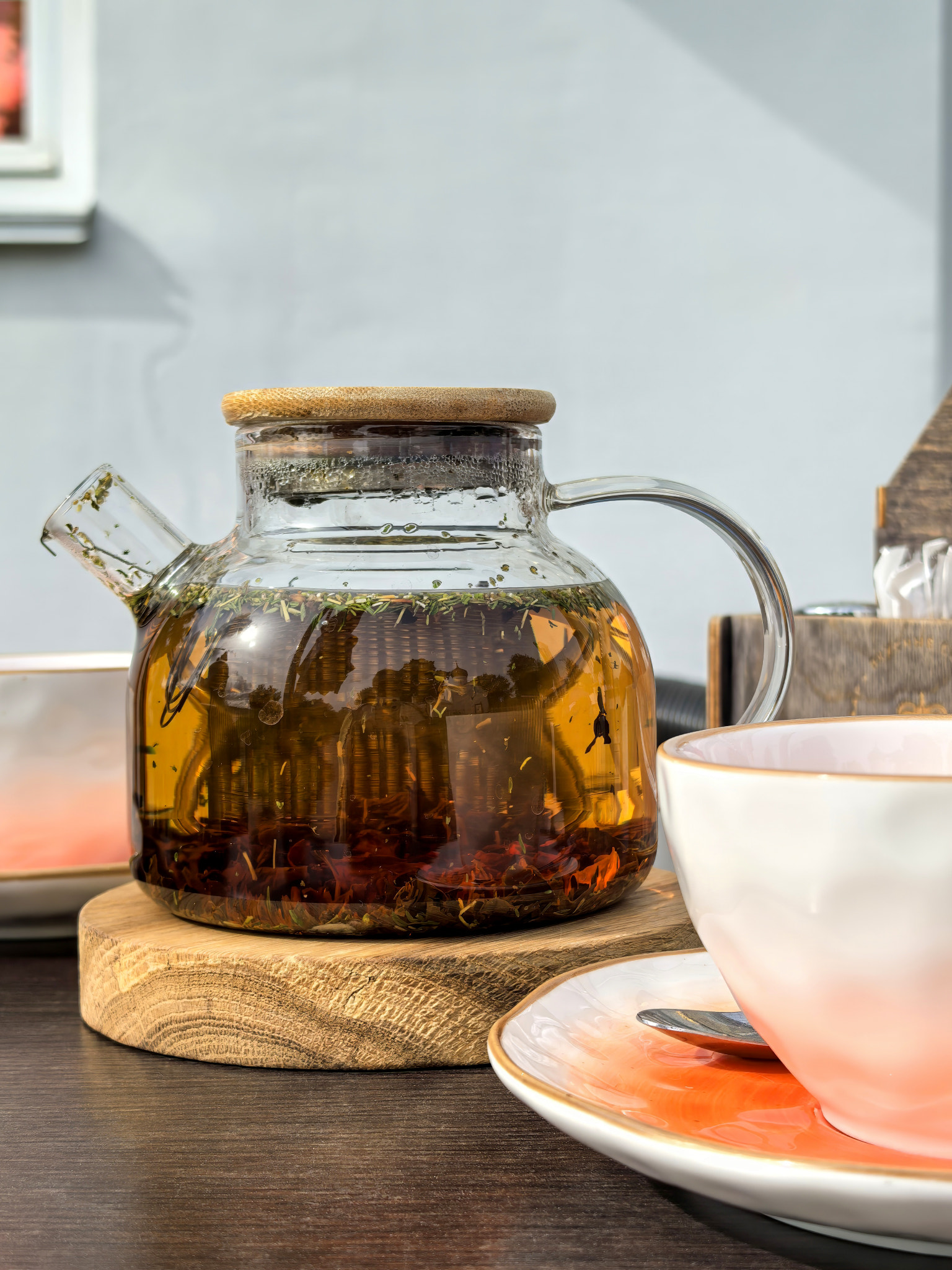 Clear Glass Teapot with Herbal Tea and Cup