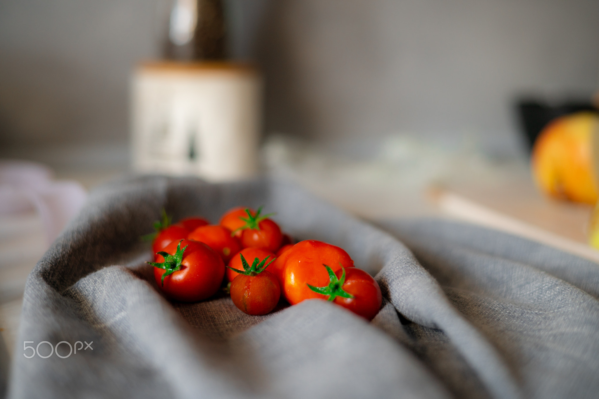 Ripe cherry tomatoes over stone kitchen table. Top view with copy spa