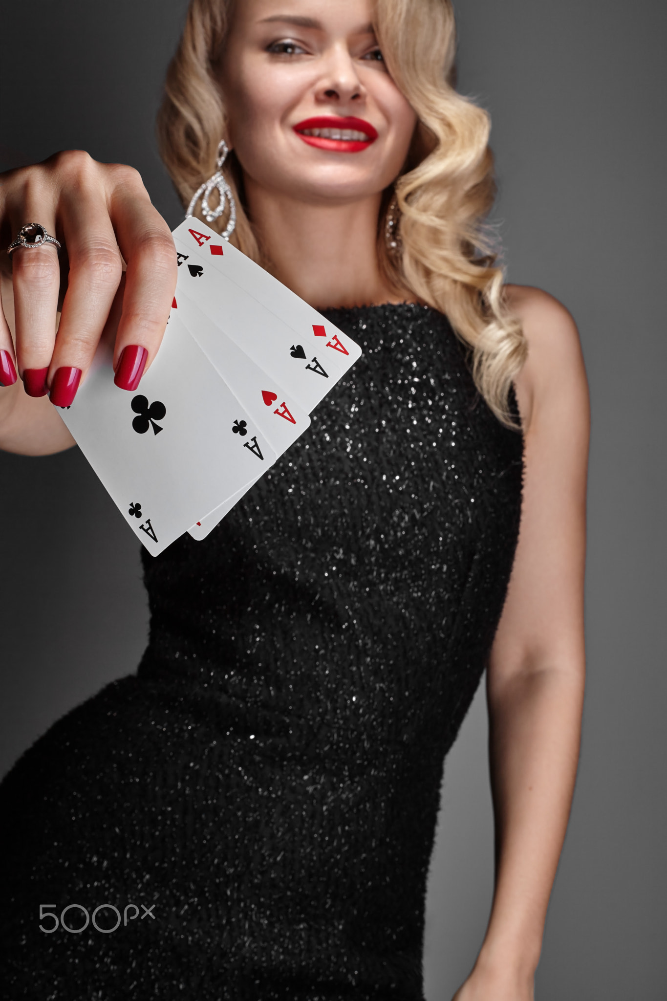 Blonde lady woman in black shiny dress and expensive diamond jewelry is winner money from Omaha