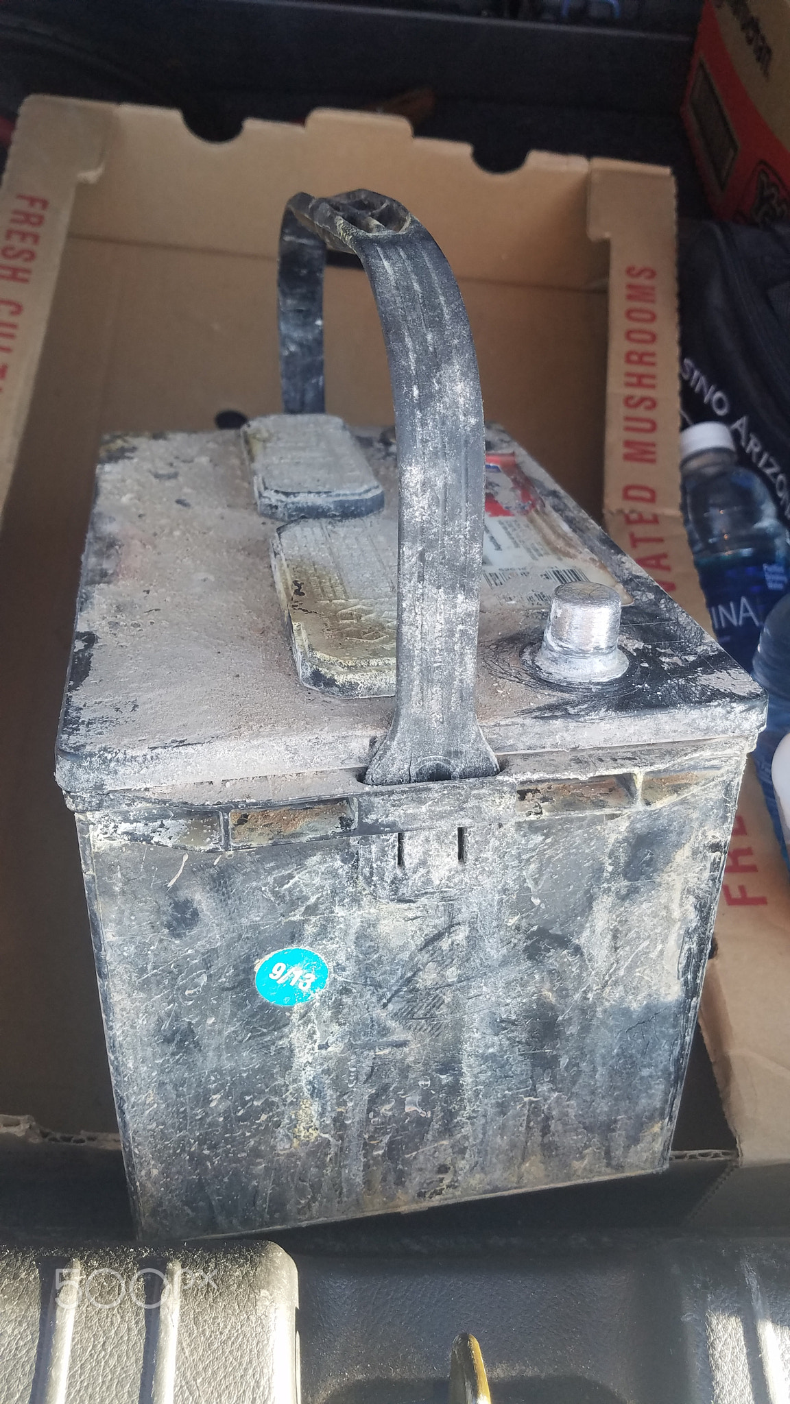 Old Crusty Car Battery in Garage for Scrap or Core Deposit