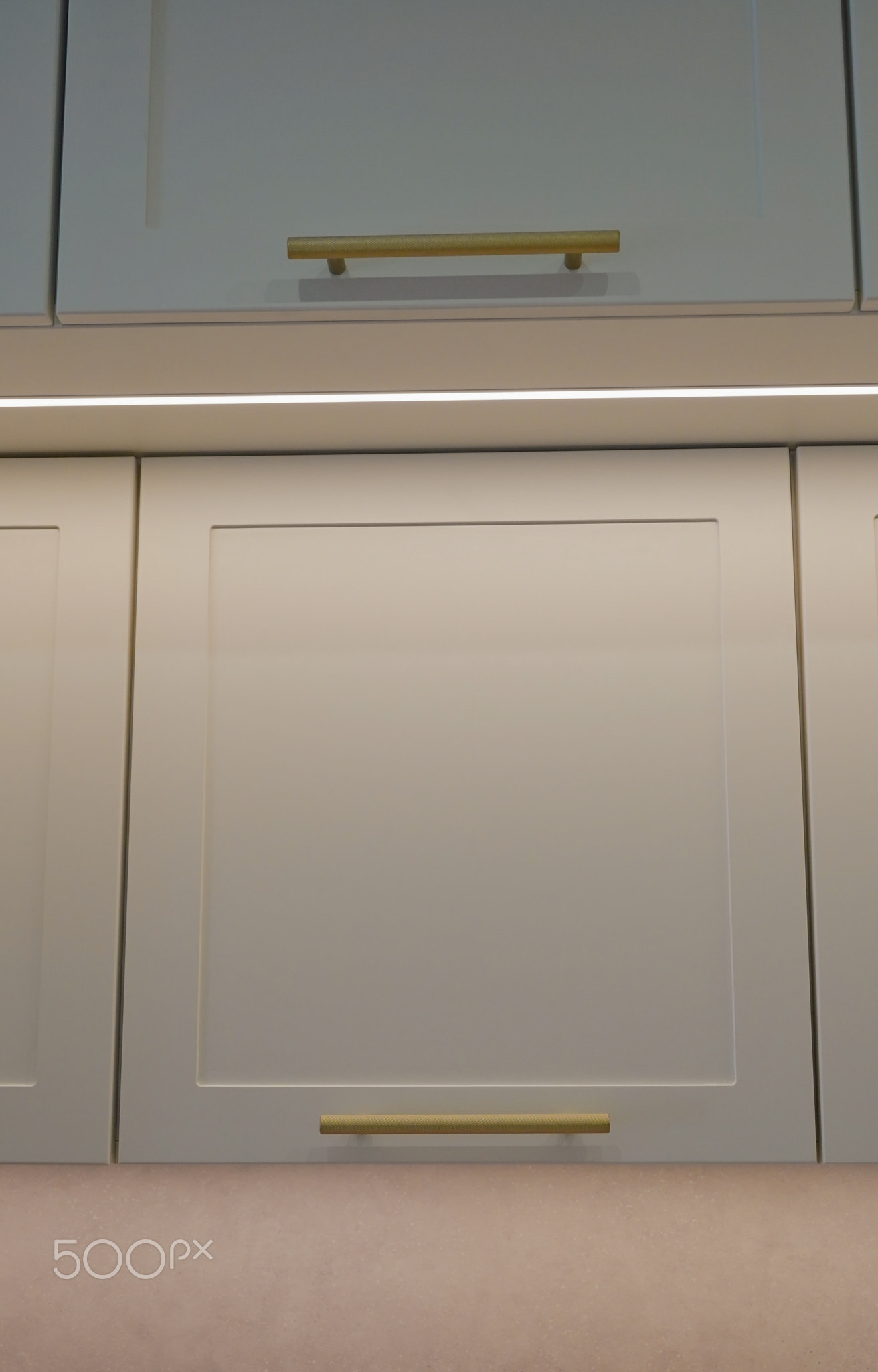 Modern kitchen cabinet design with sleek handles and subtle lighting in a stylish home setting