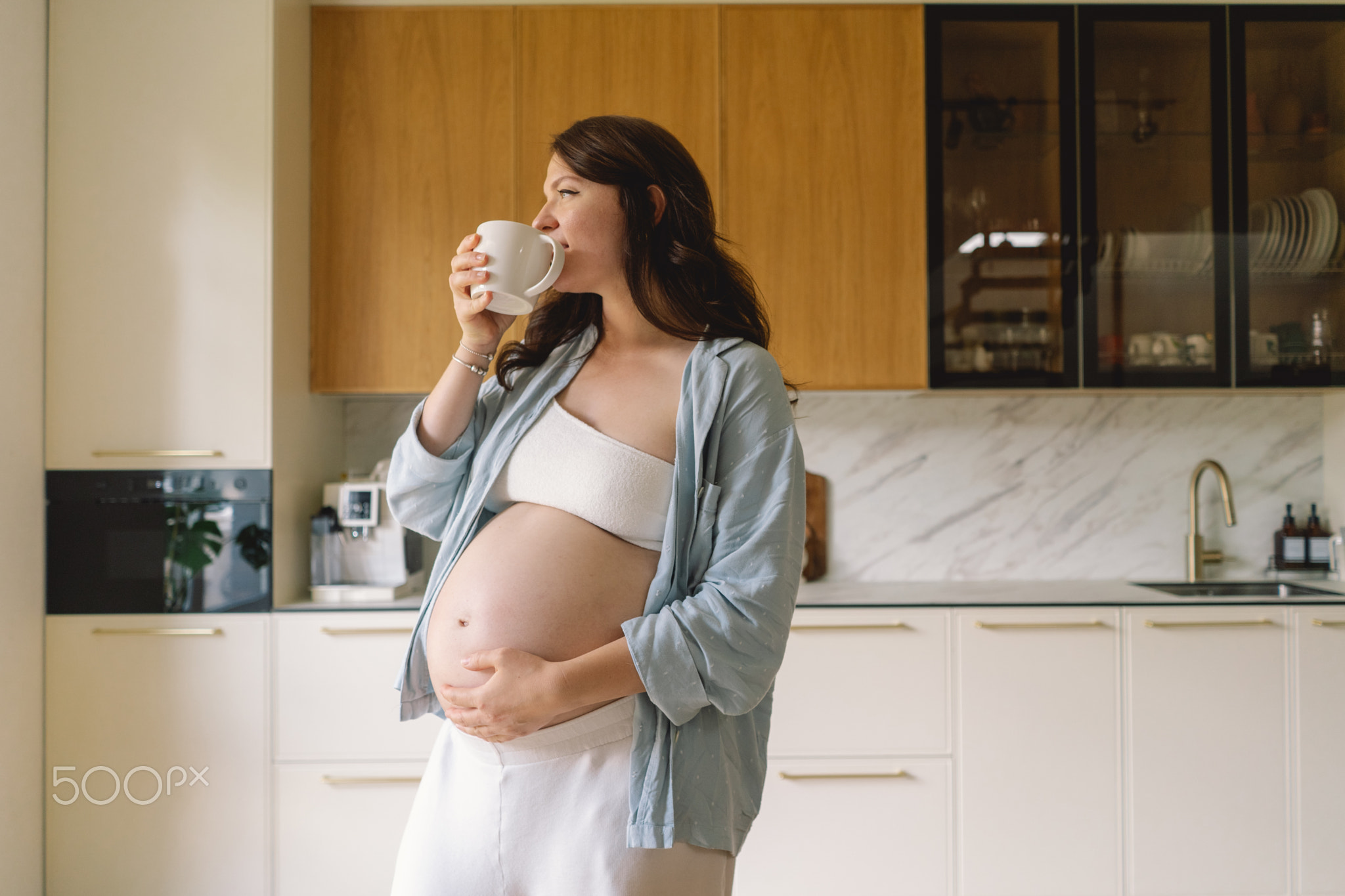 Expecting mother enjoys a warm drink