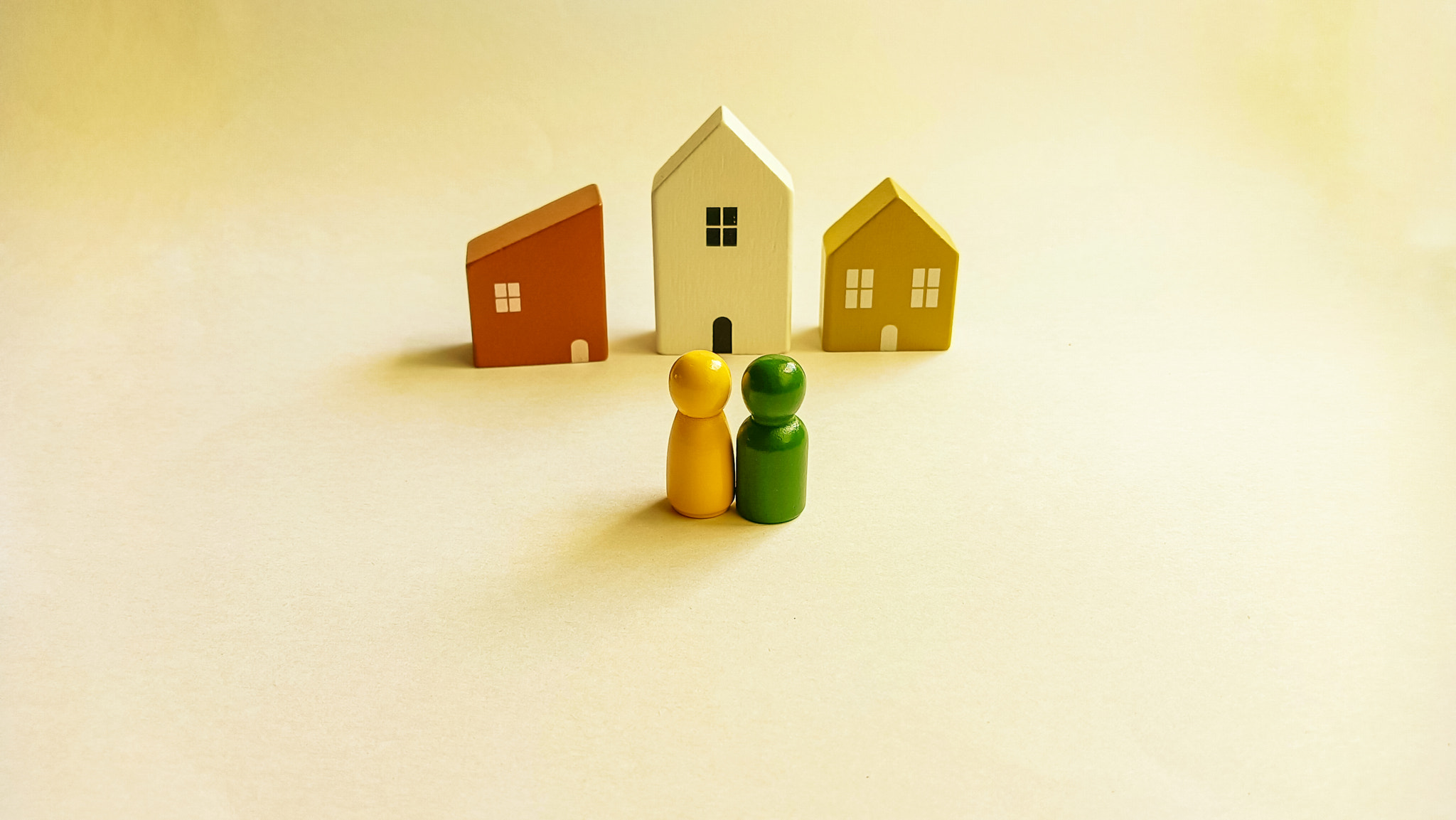 Miniature Couple Looking at Small Houses Representing Real Estate and 