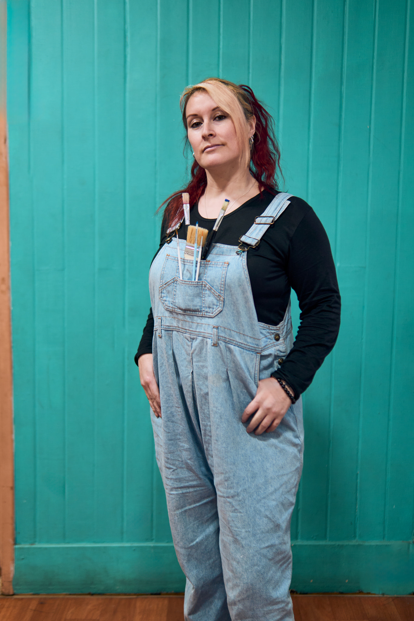 Portrait of a beautiful, cheerful, redheaded Latina adult woman posing with attitude