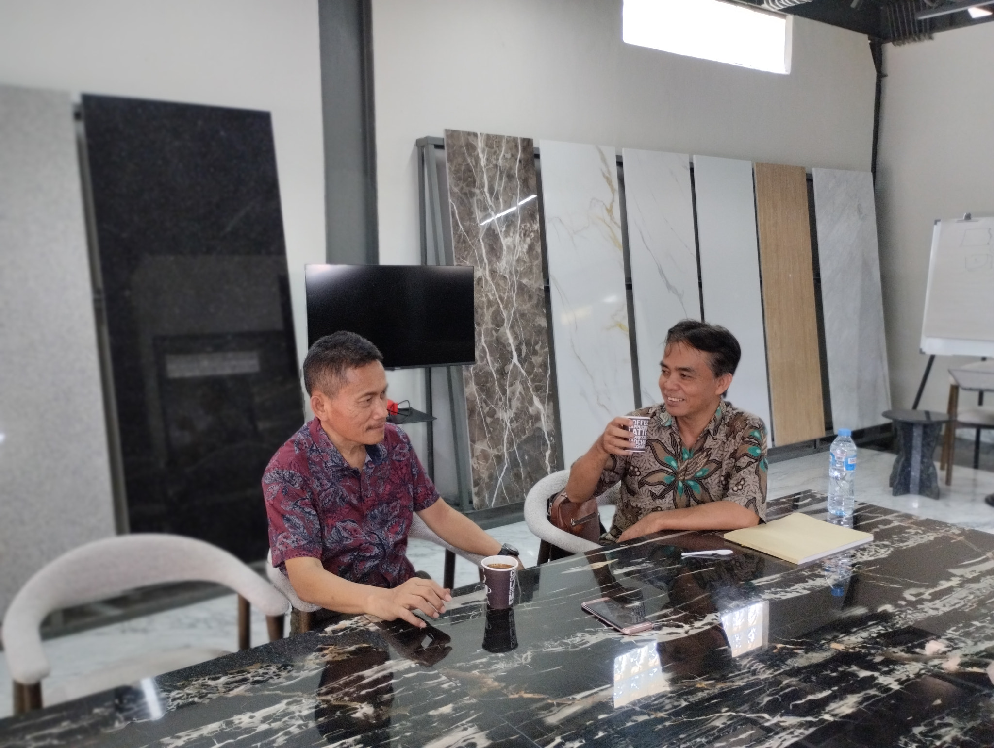 Business Meeting with Coffee in Marble Showroom. Editorial use only