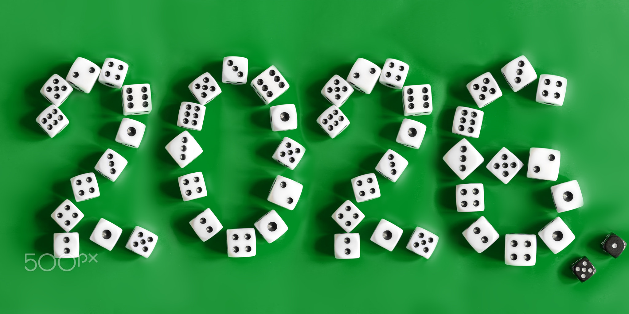 Number 2026 is creatively formed with white dice on vibrant green background, symbolizing luck