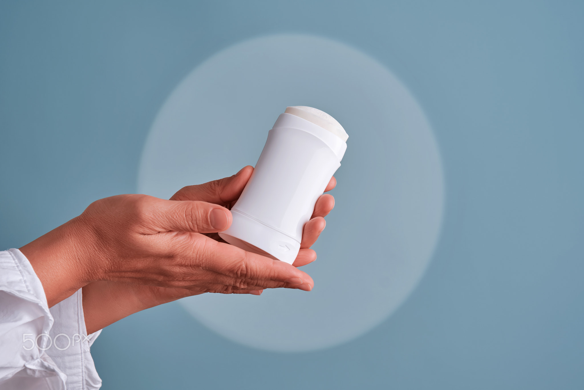 Hands holding white deodorant stick personal hygiene