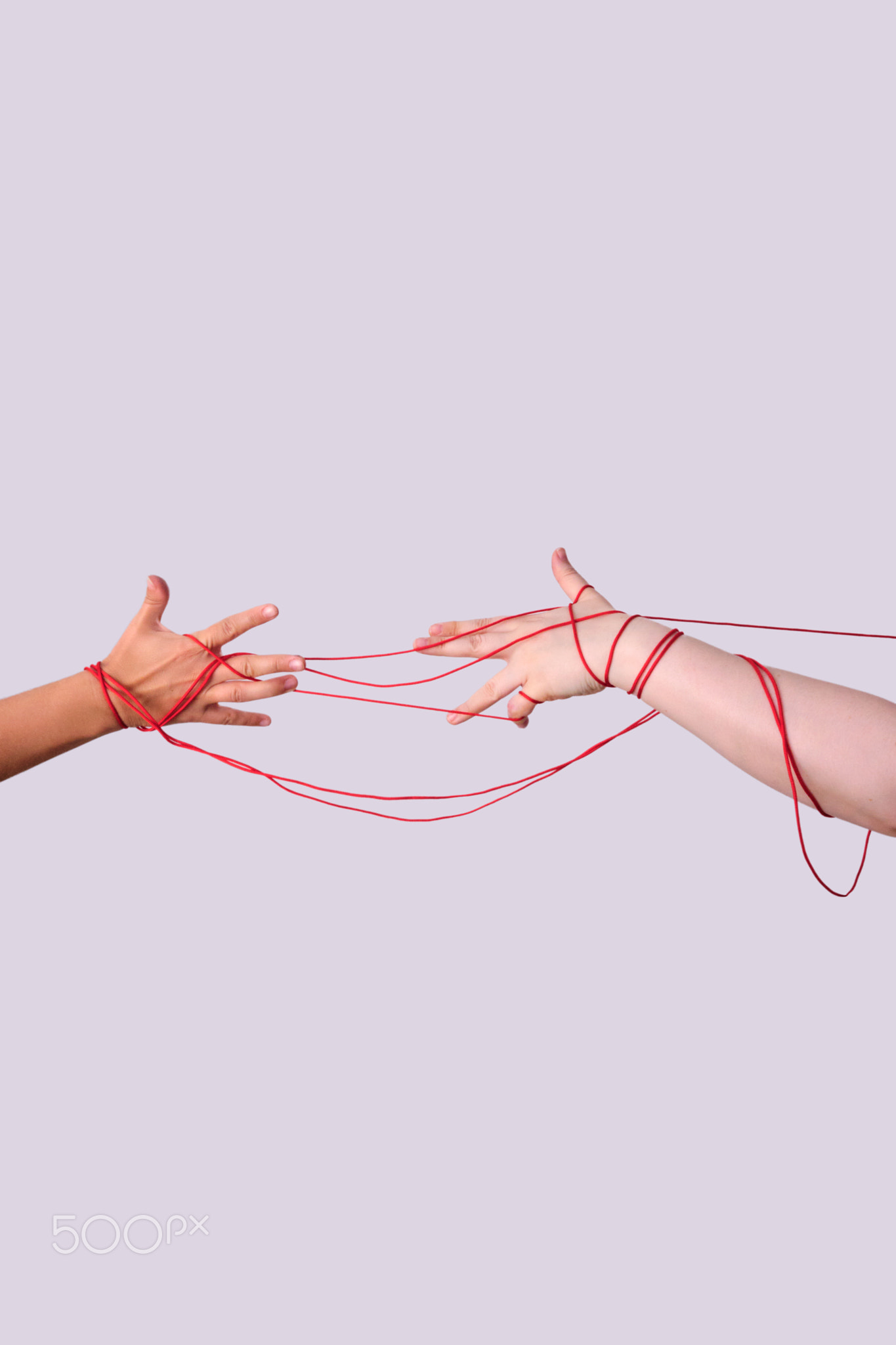 Hands connected by red string of fate