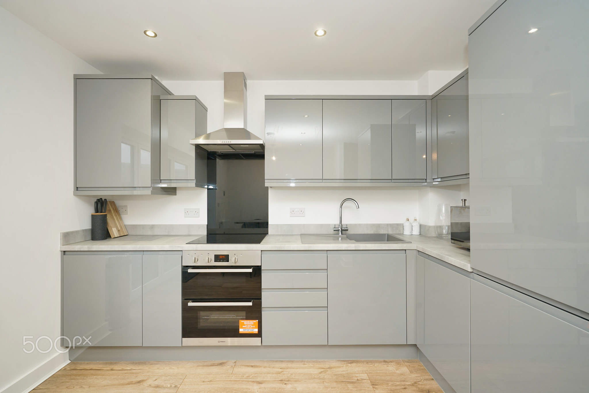 Modern gray kitchen with sleek appliances and minimalist design in a contemporary home