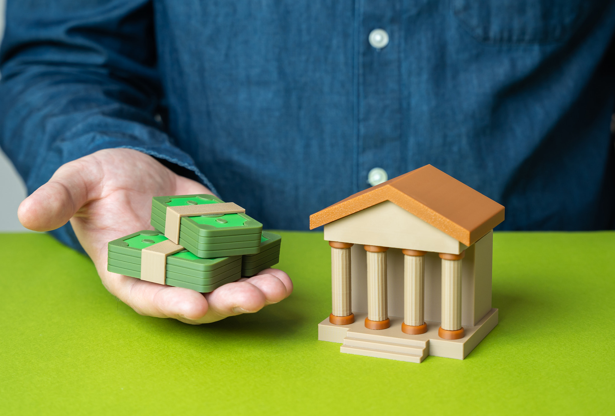 A man makes a deposit into a bank. Symbol of savings, investment and financial growth. Useful for bu
