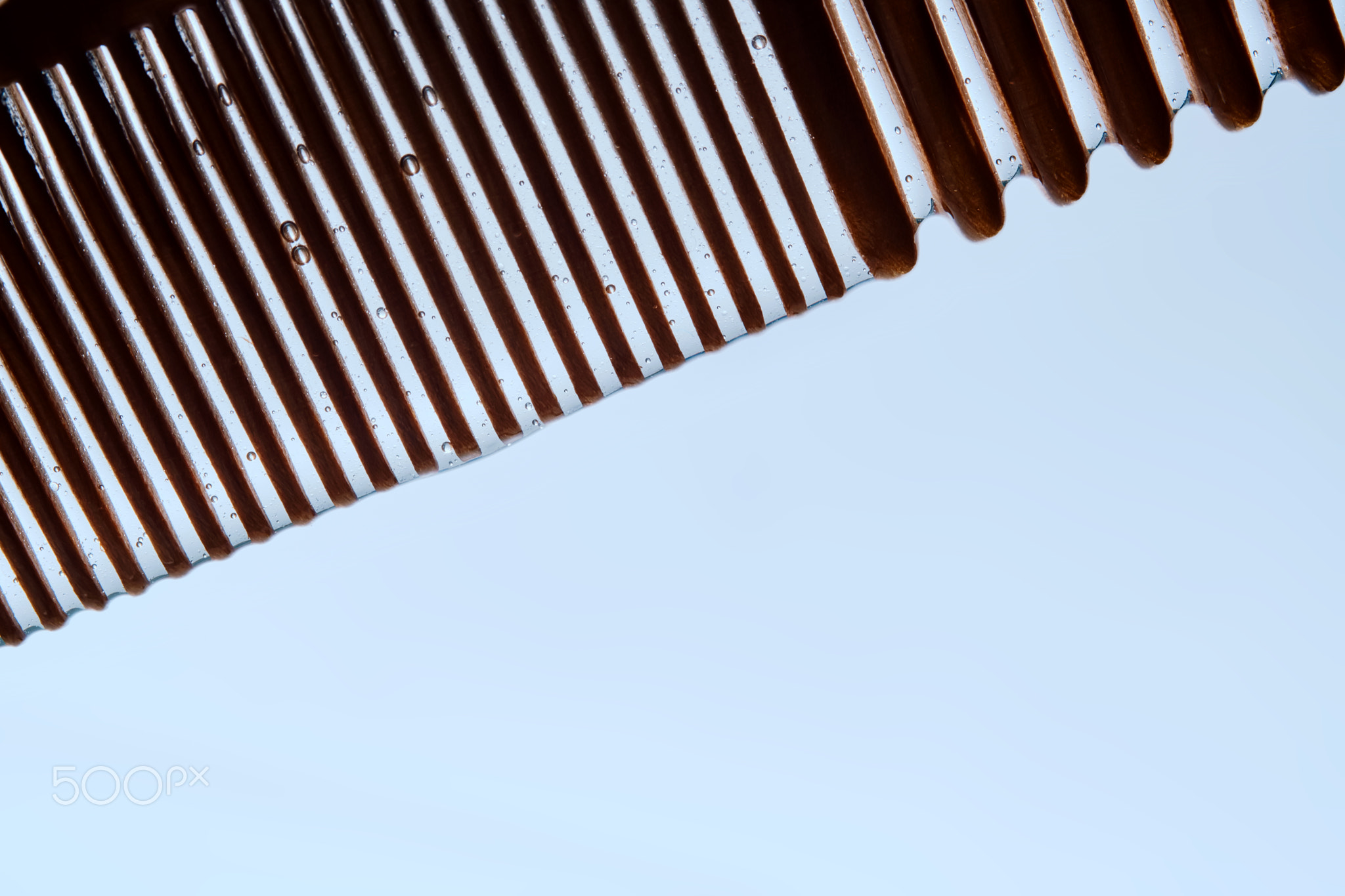 A comb with hair serum. The photo shows the texture of the cosmetic product.