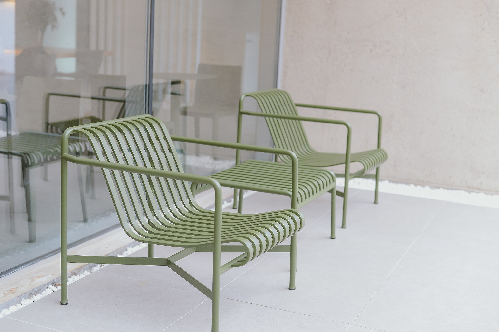 Modern Minimalist Interior with Contrasting White Walls and Green Chairs