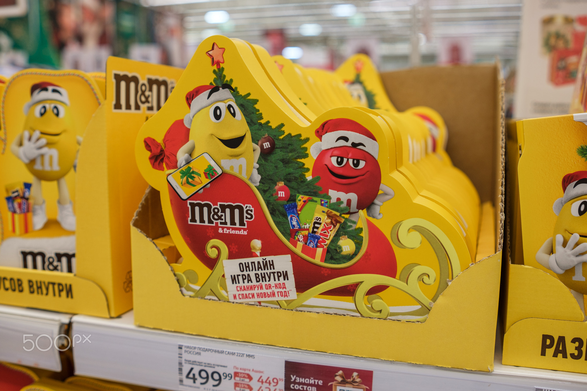 Colorful Holiday Display of Candies Featuring Characters Celebrating Christmas in a Store Aisle