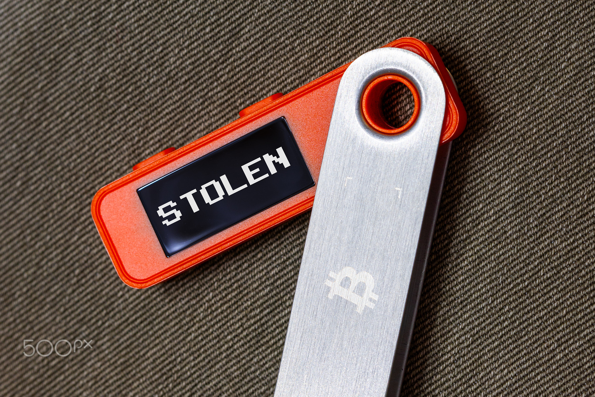 hardware Bitcoin wallet with message Stolen on screen