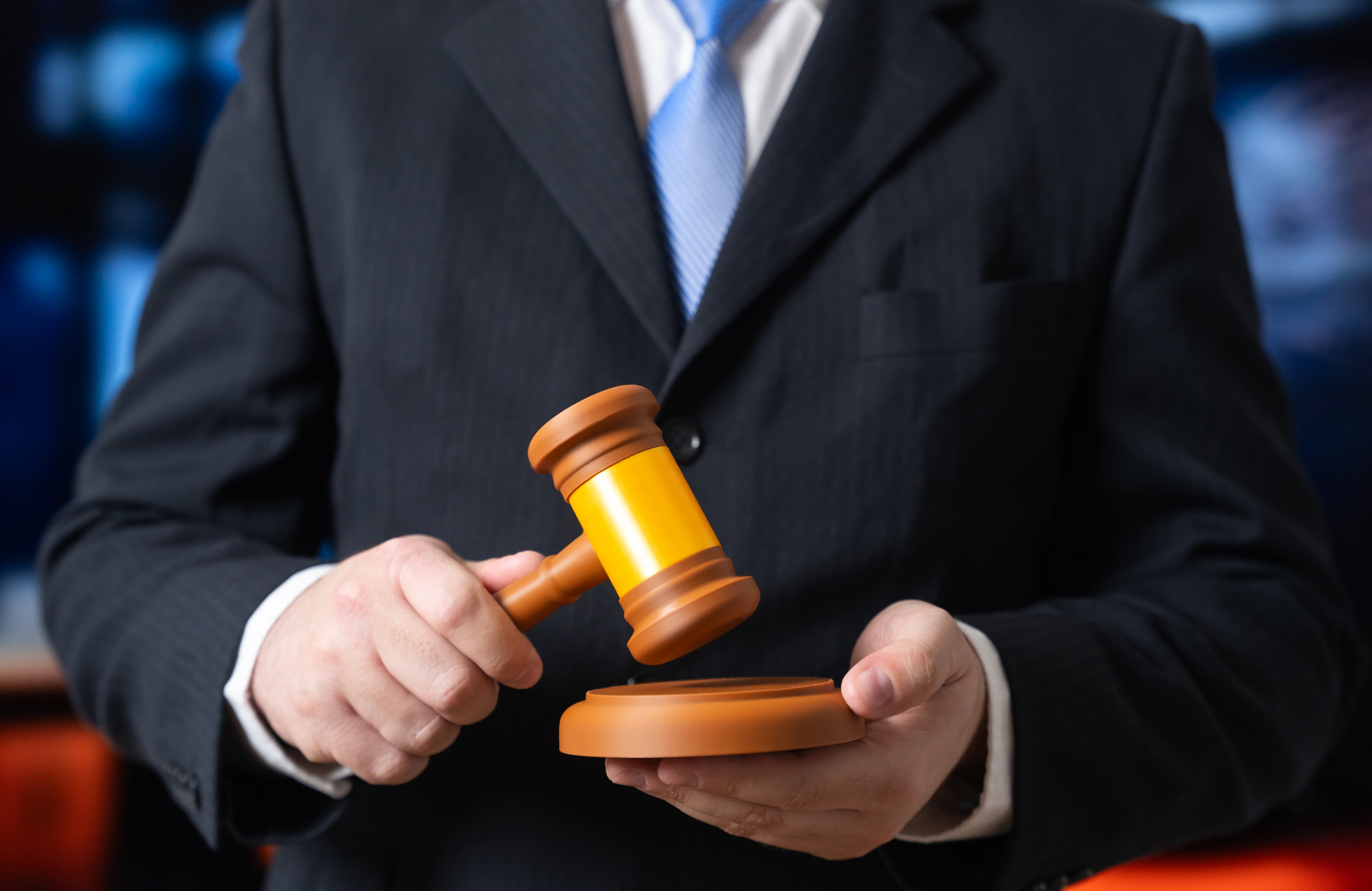 A man in a suit holding a judge's gavel. Judge and justice. Top officials and lawmaking. Legal refor