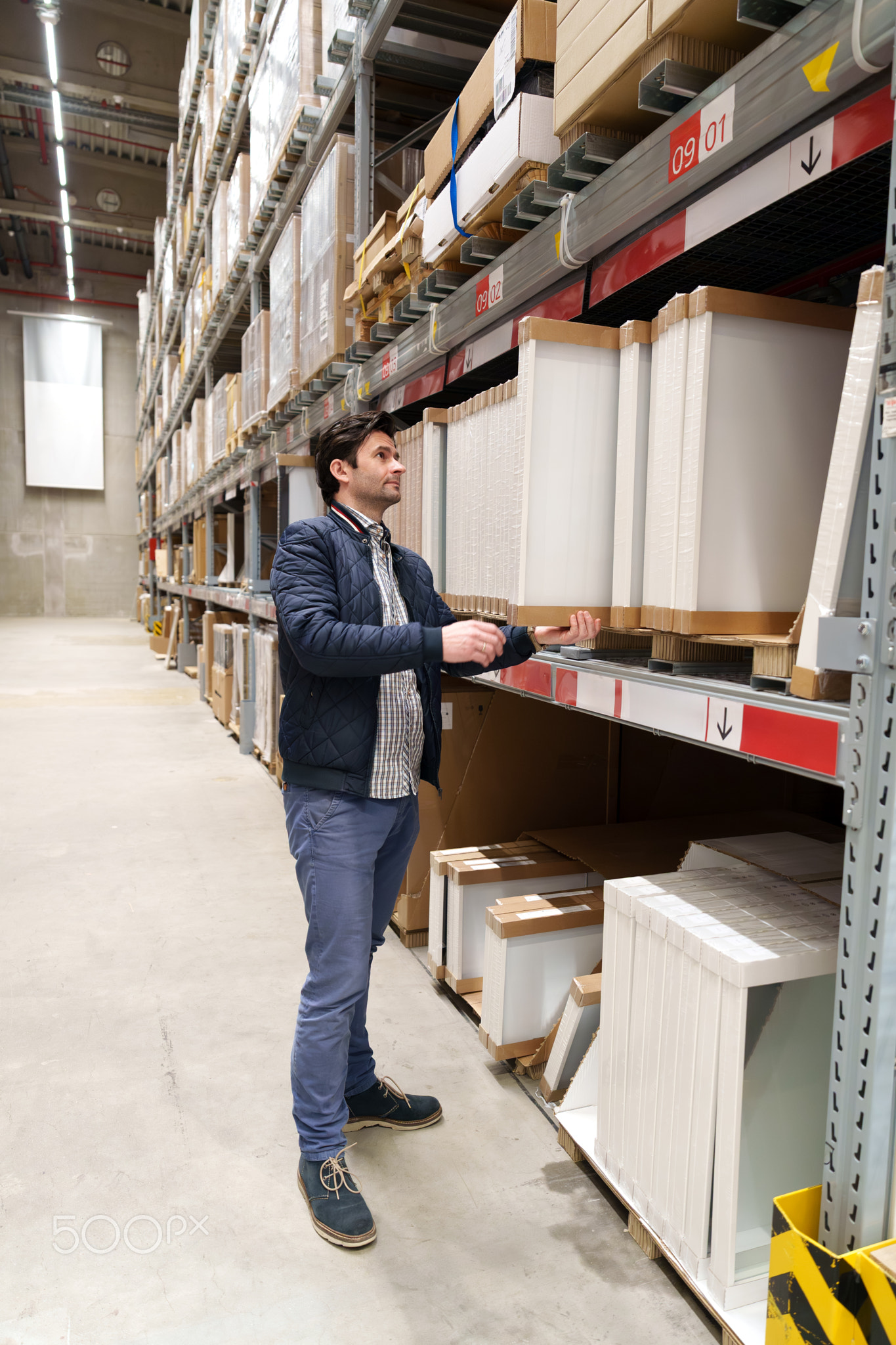 Man choosing furniture in warehouse store