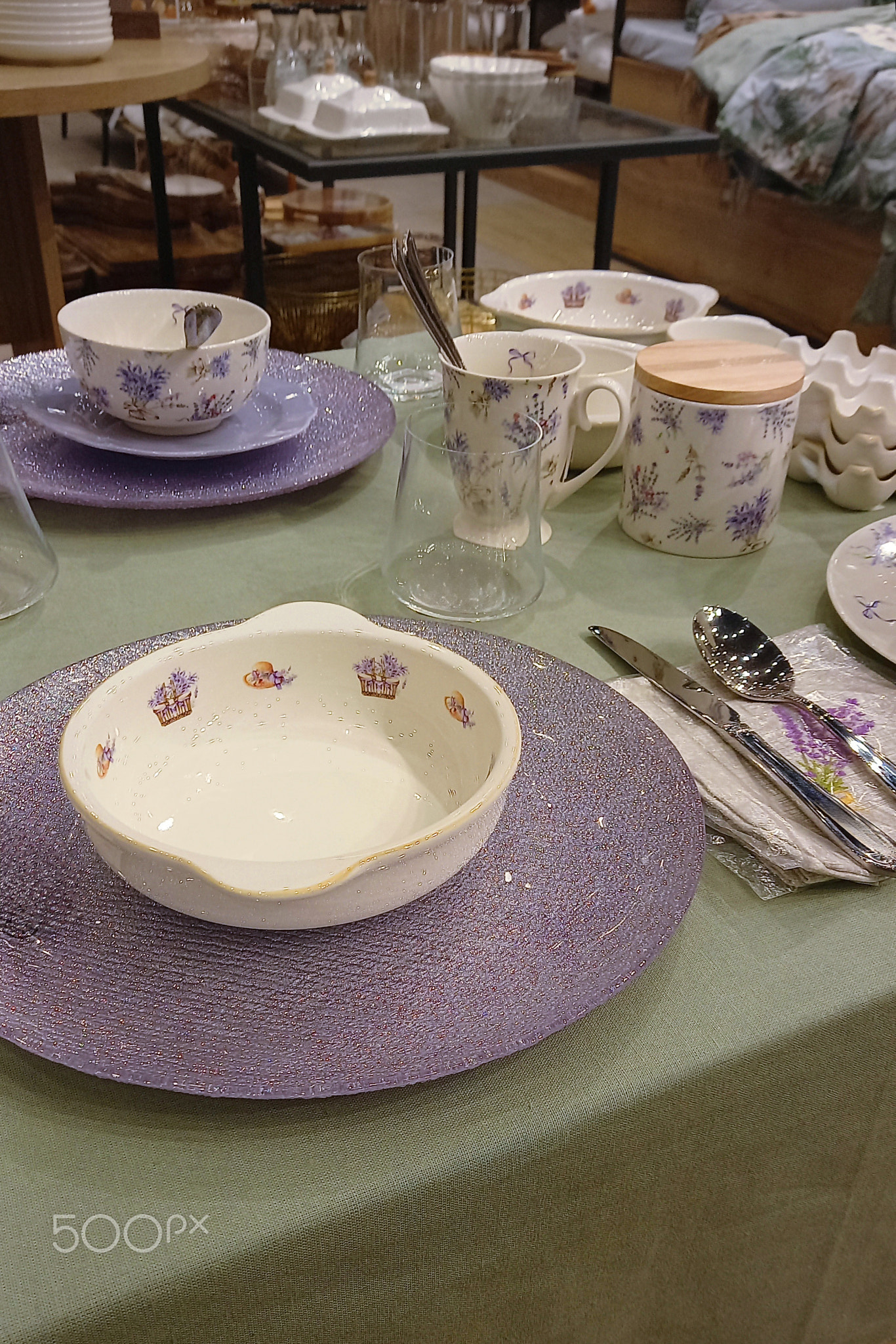 Elegant arranged table setting featuring delicate lavender floral patterns on ceramic dishes in