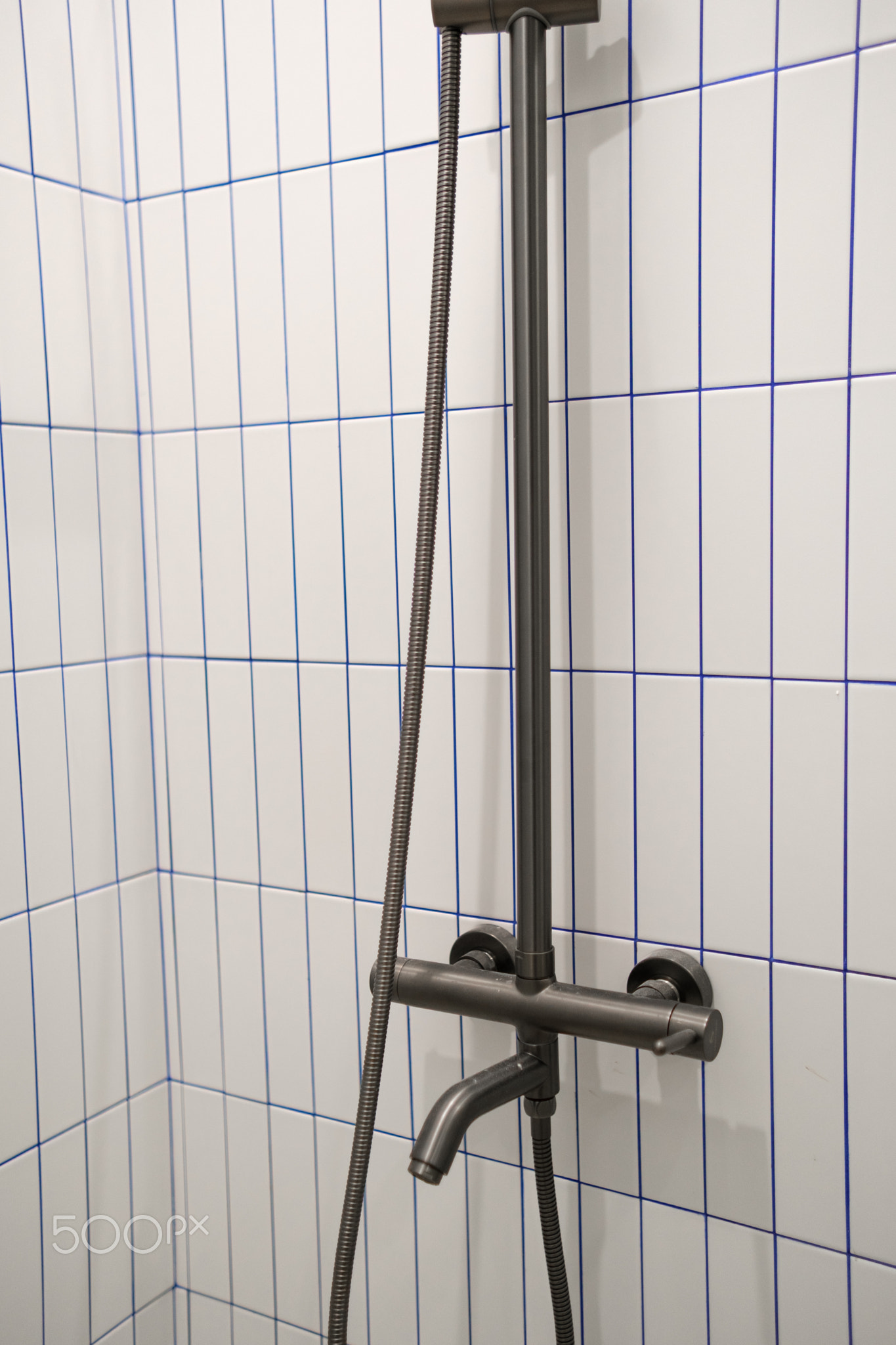 Shower Fixture and Tile Design in a Modern Bathroom Setting Showing Details of the Plumbing