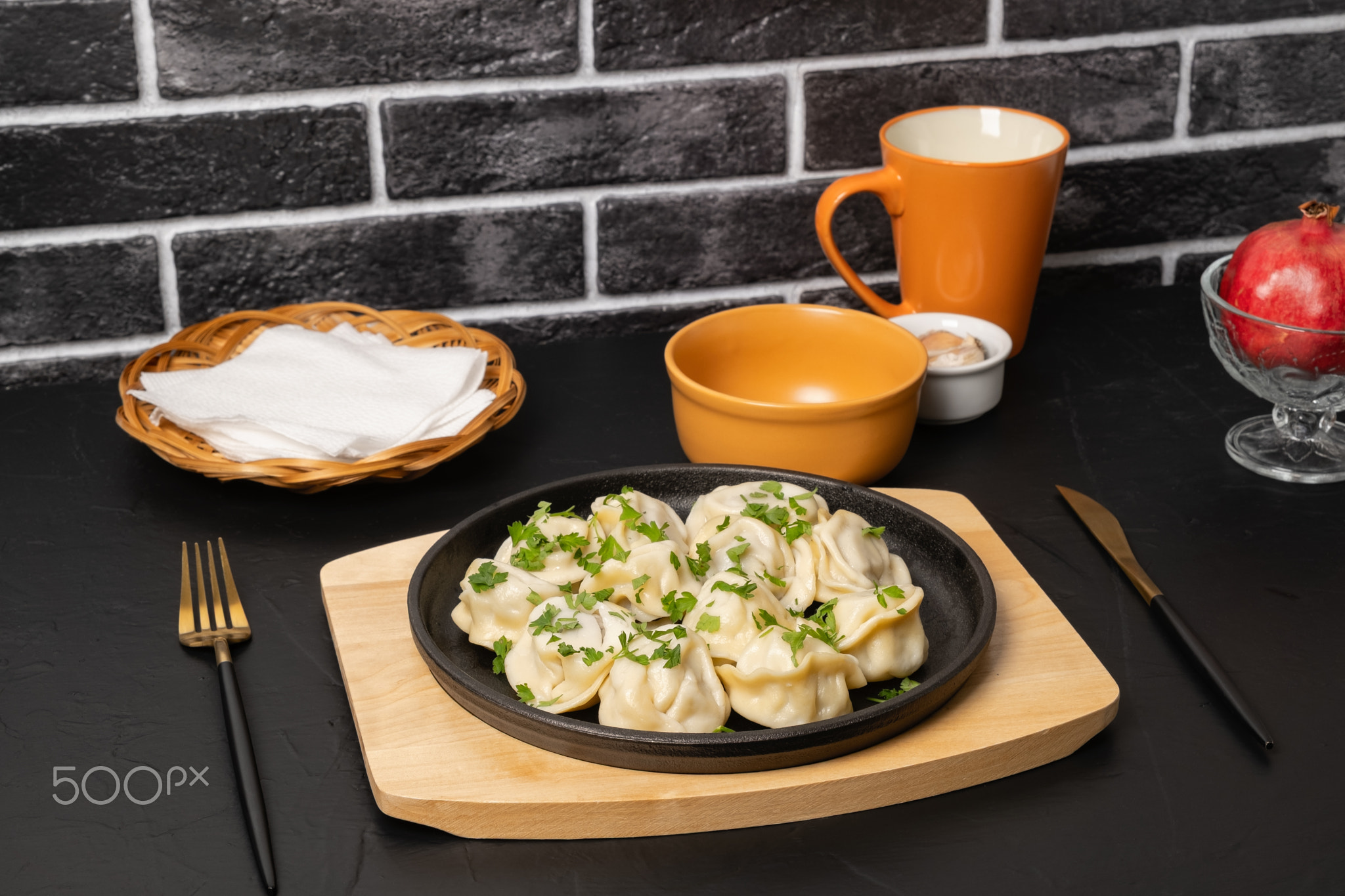 Delicious dumplings served on a black plate in a cozy dining setting