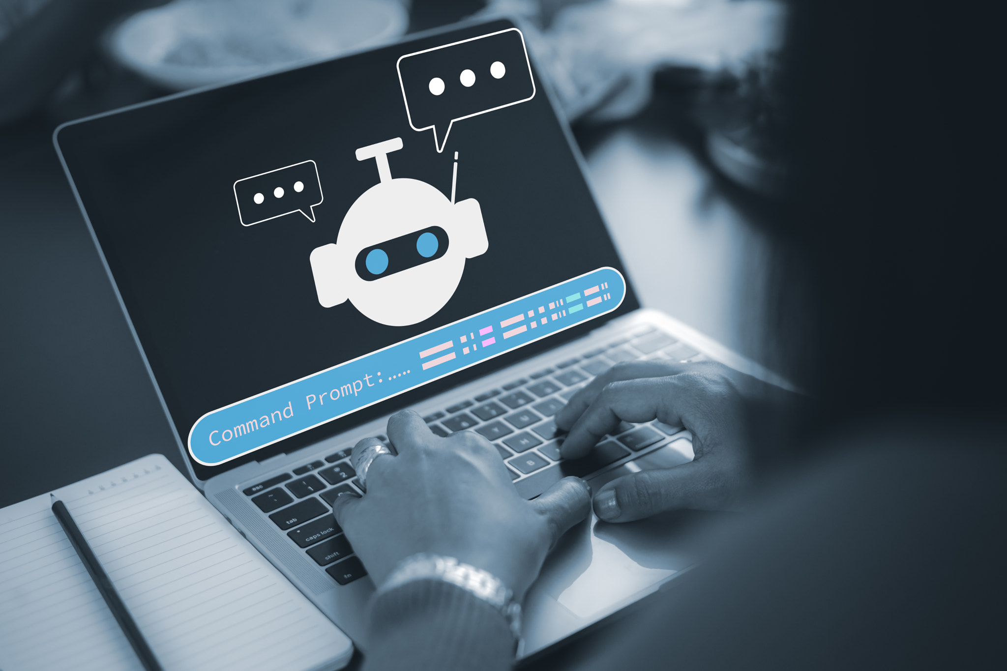 Close up of hands typing on laptop keyboard with AI chatbot icon and command prompt on screen, provi