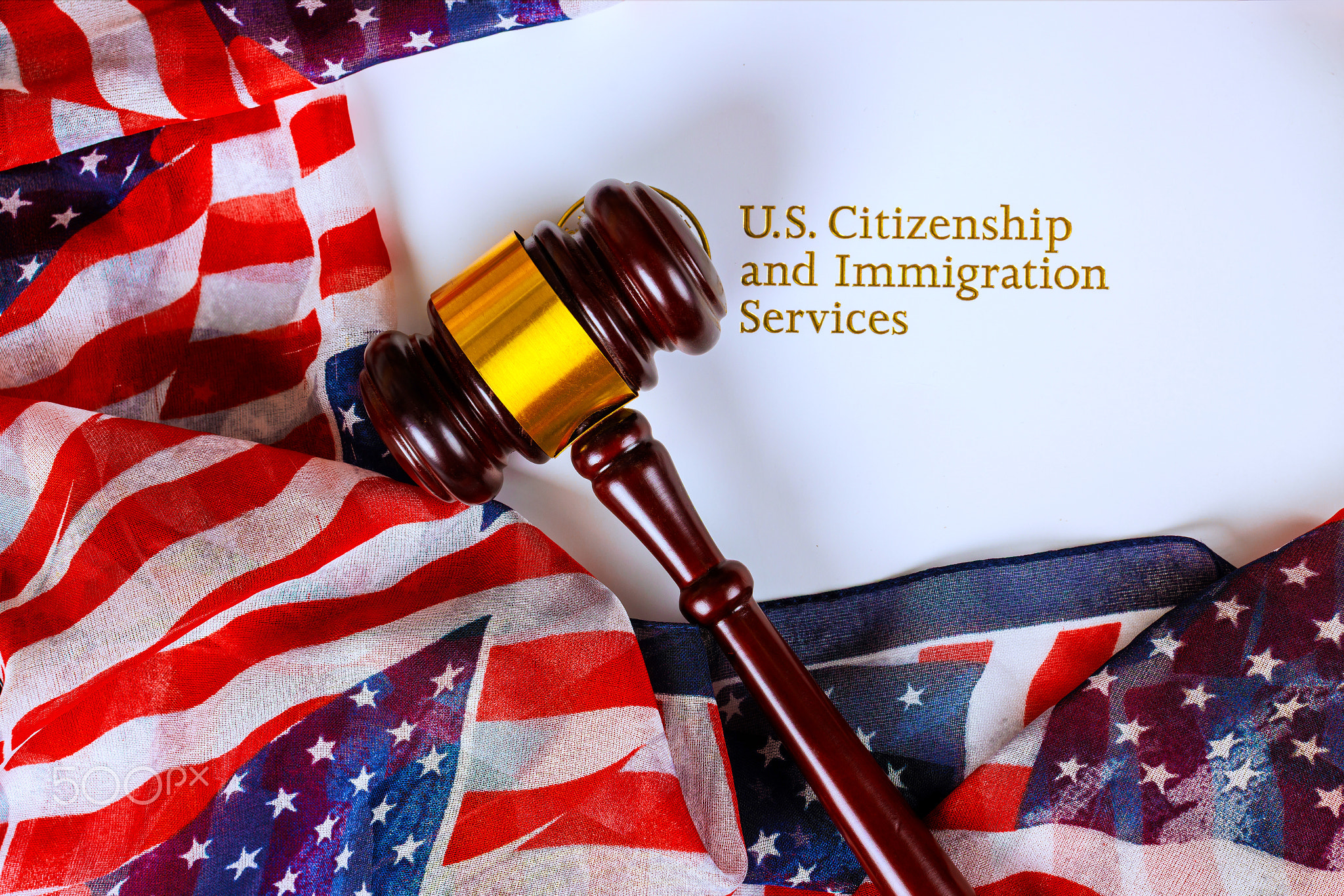 Gavel rests on American flag fabric with U.S. Citizenship Immigration