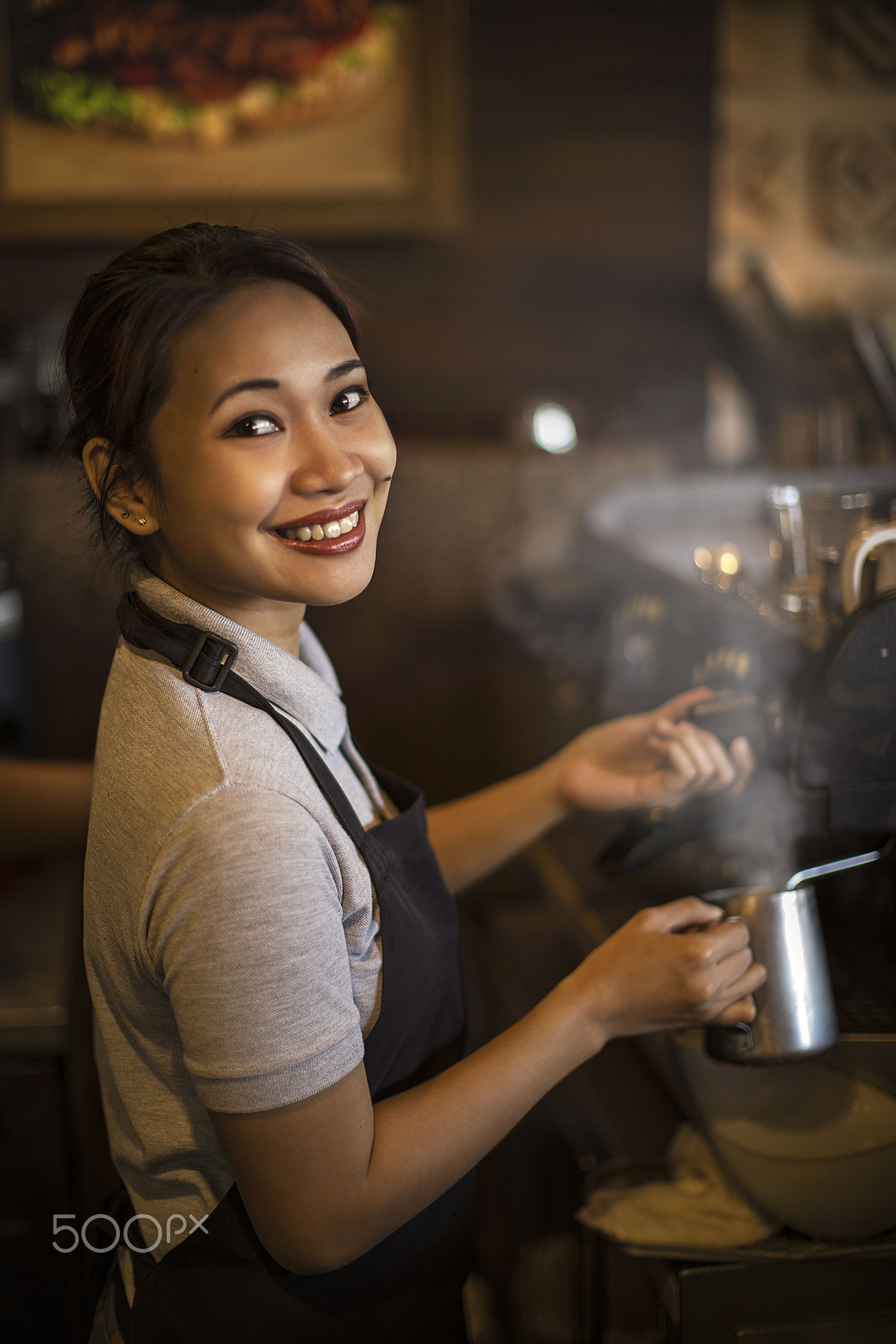 kind Waitress in a Coffee shop preparing beverages with big smile