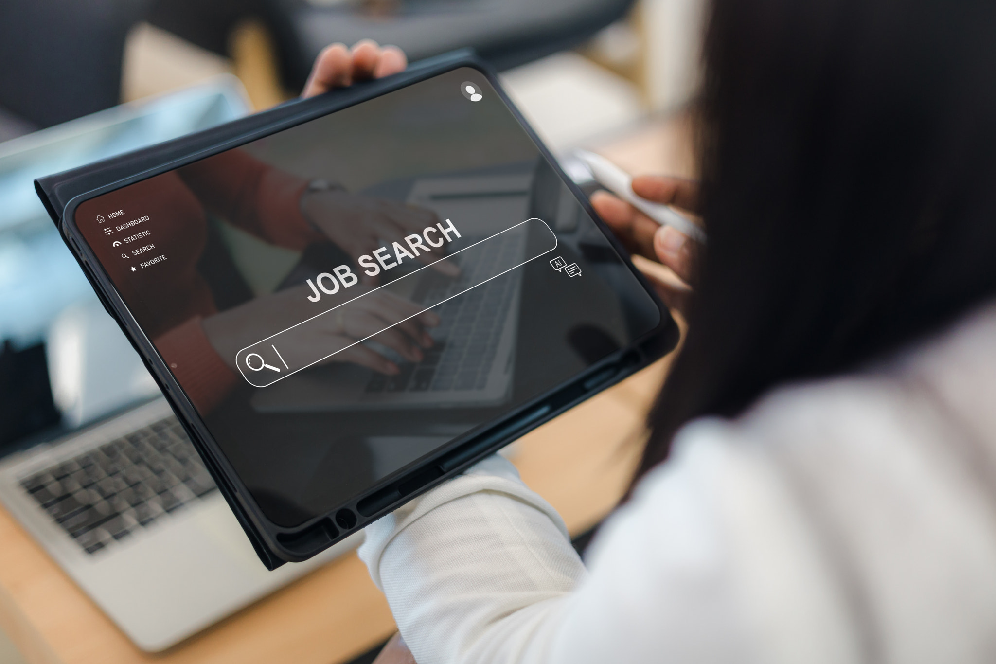 Close up of a woman using a digital tablet for job searching online via a website interface, featuri