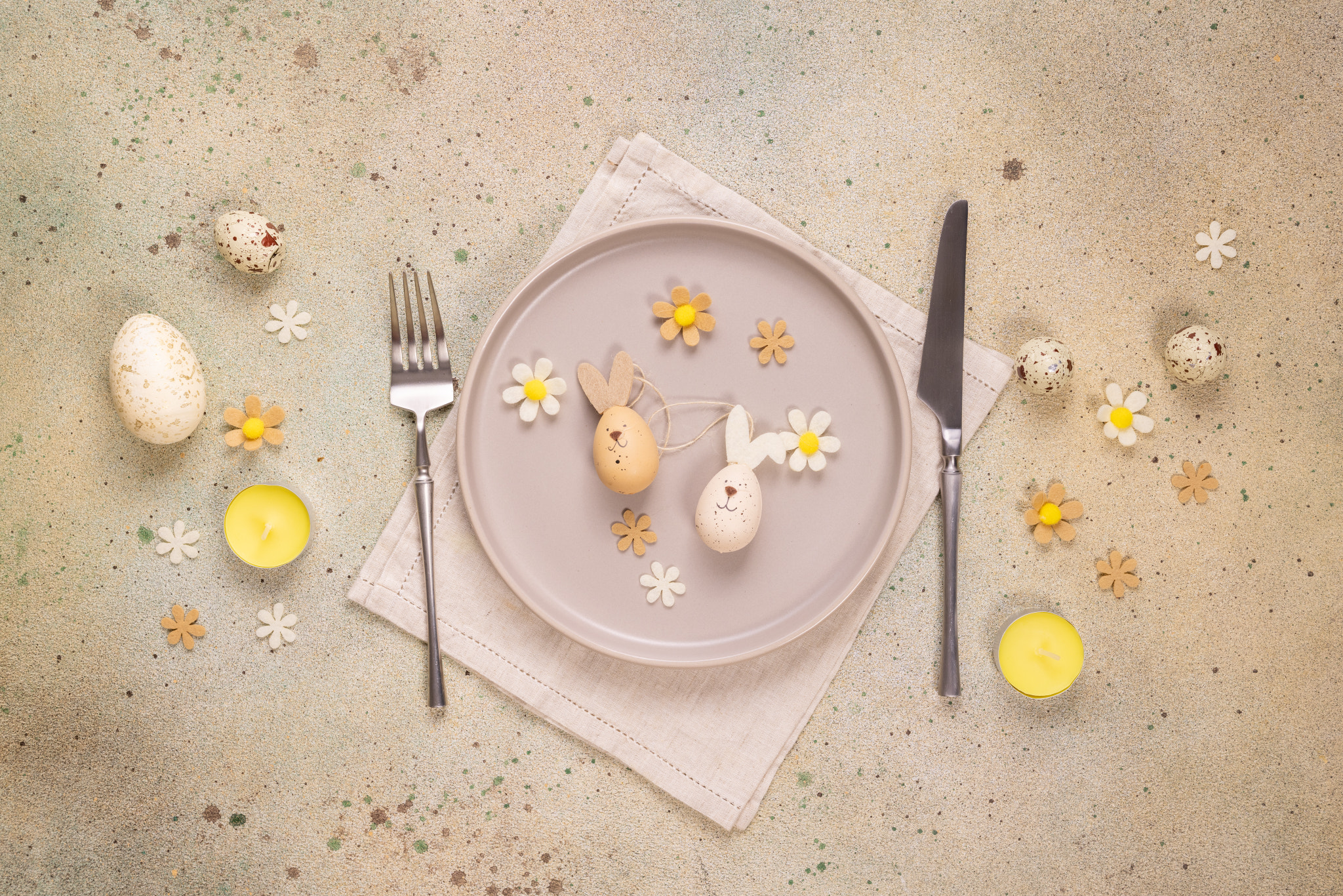 Easter table setting with bunny eggs and flowers