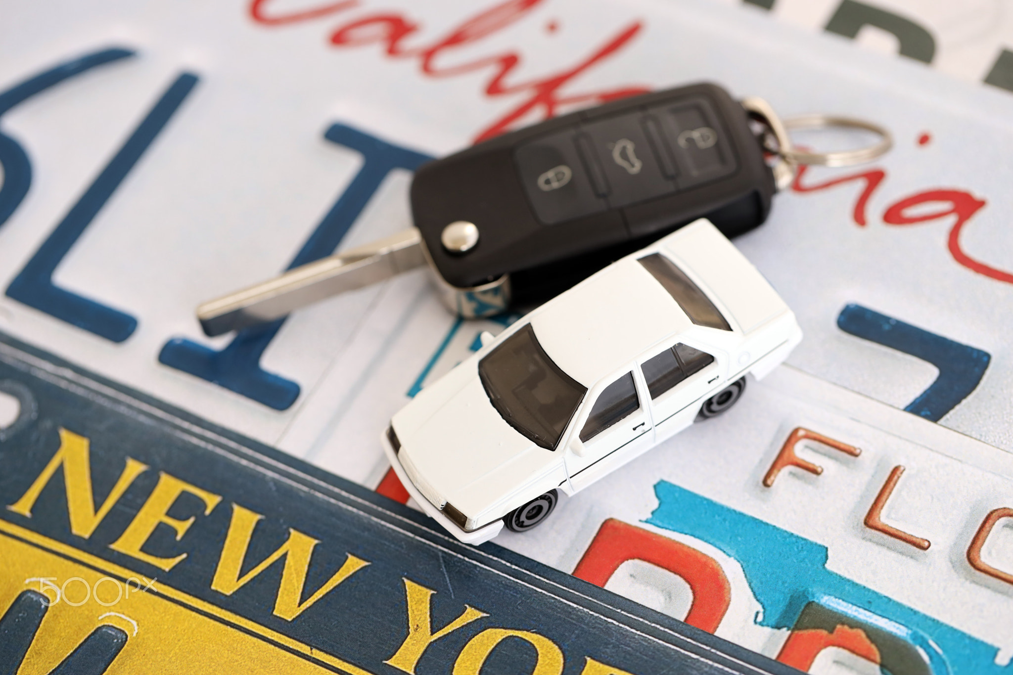 Remote control car keys on US license plates with state names. Driving in United States