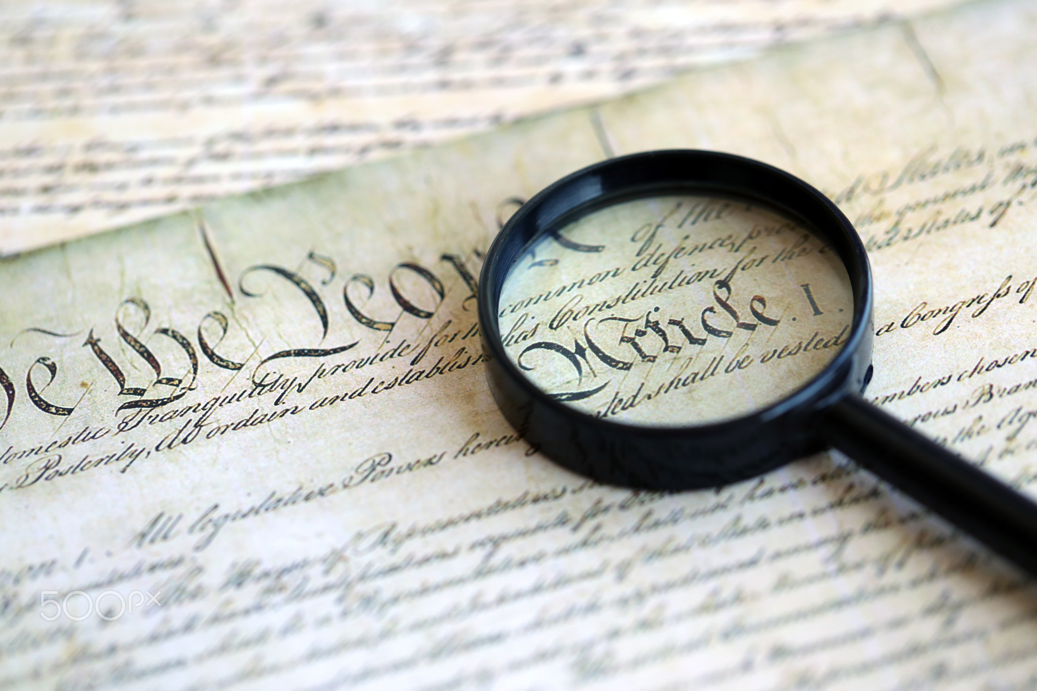 Magnifying glass and United States Constitution. American USA Constitution paper page and loupe