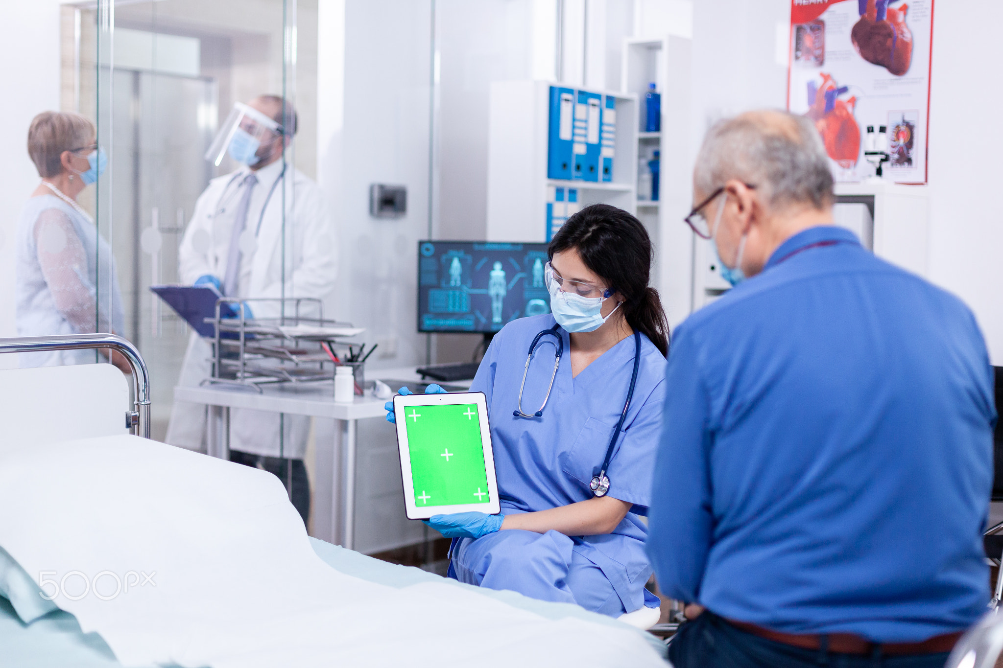 Patient looking at tablet with green screen