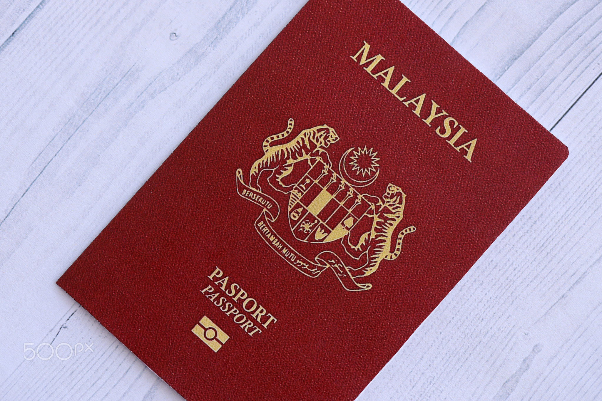 Malaysian passport on table. Official identification document book for citizens of Malaysia