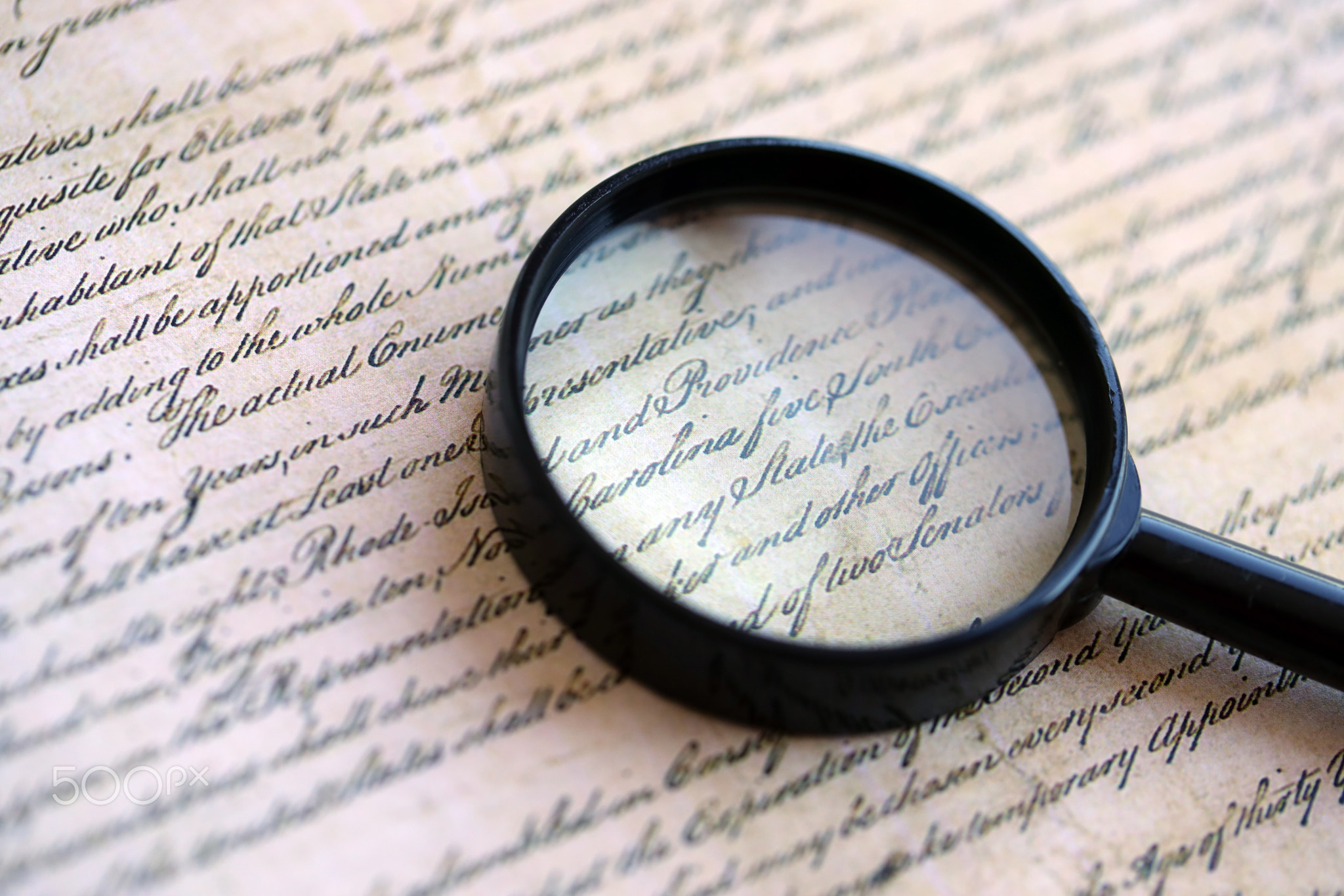 Magnifying glass and United States Constitution. American USA Constitution paper page and loupe
