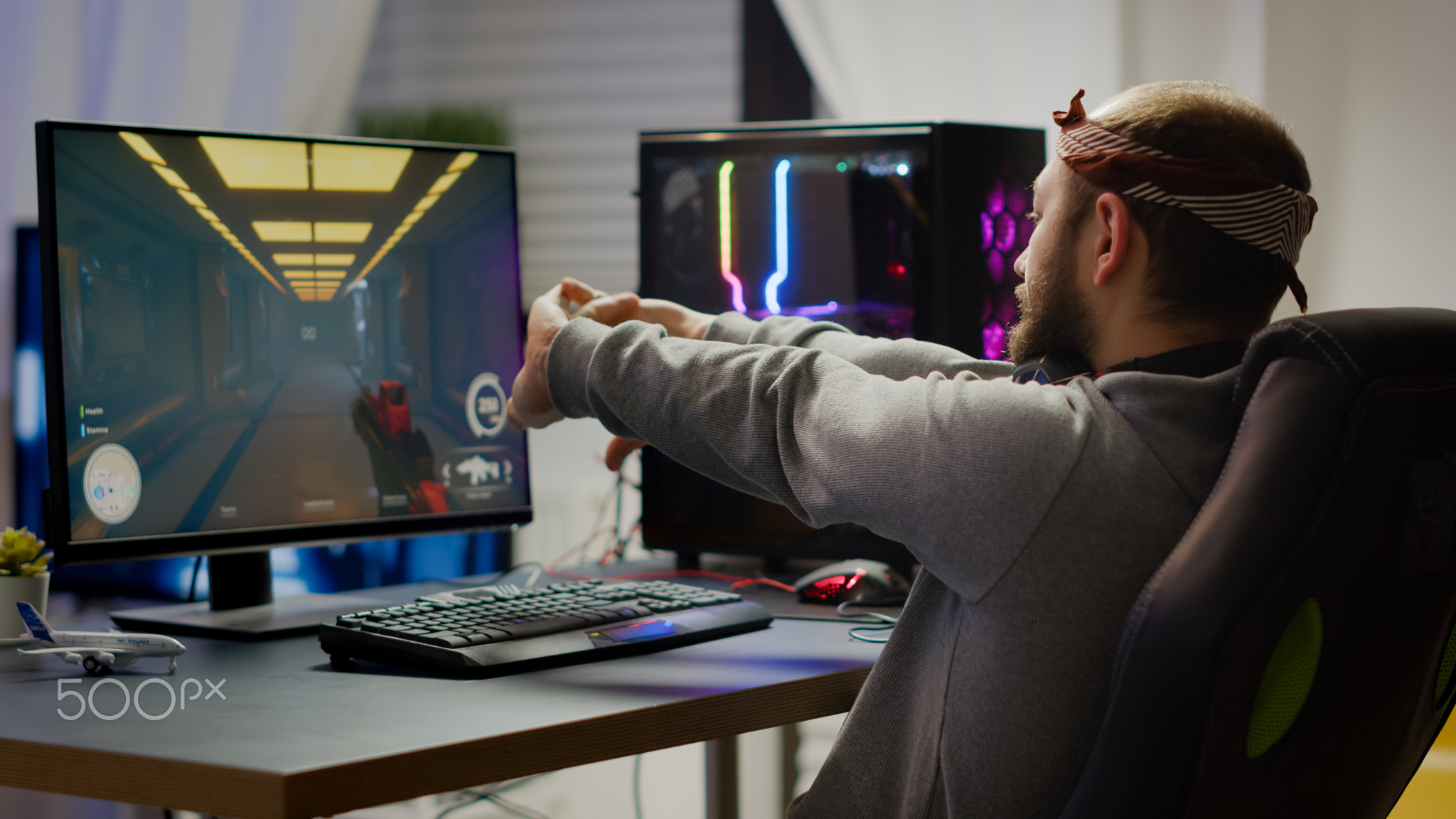 Competitive gamer streatching hands sitting on gaming chair