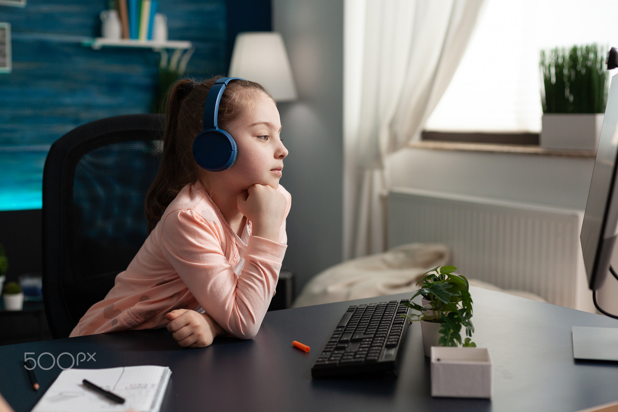 Caucasian student wearing headphones on online class