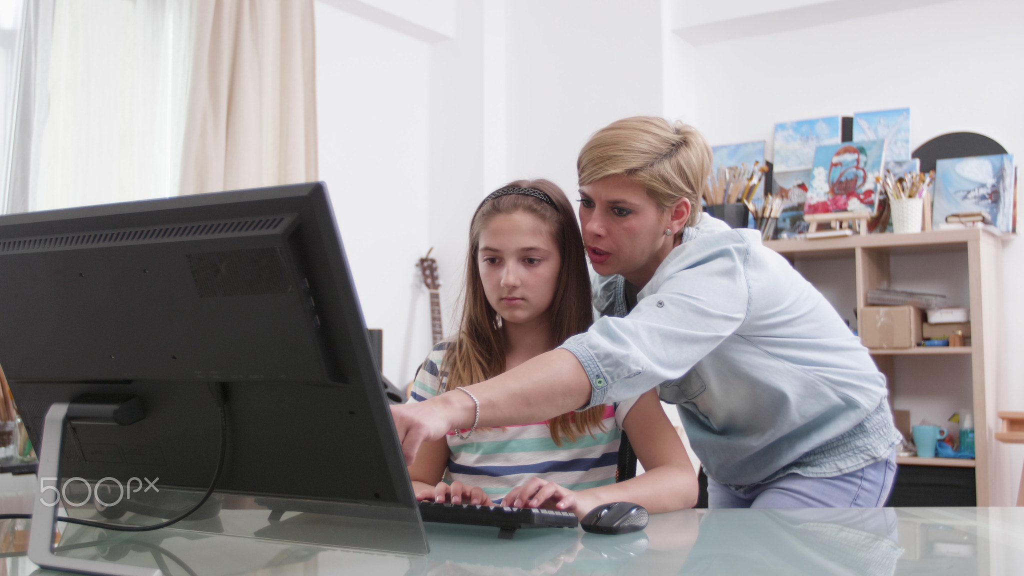 Mother helping daughter with school homework analyzing mathematics lesson