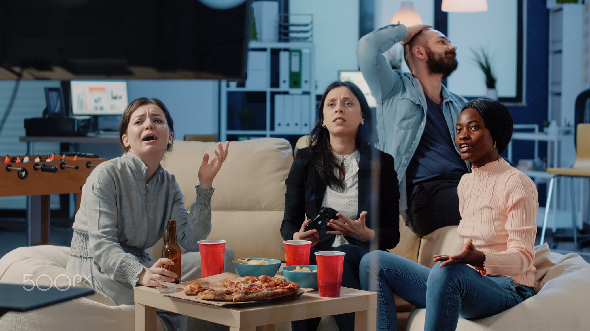Colleagues having fun with video games and joysticks
